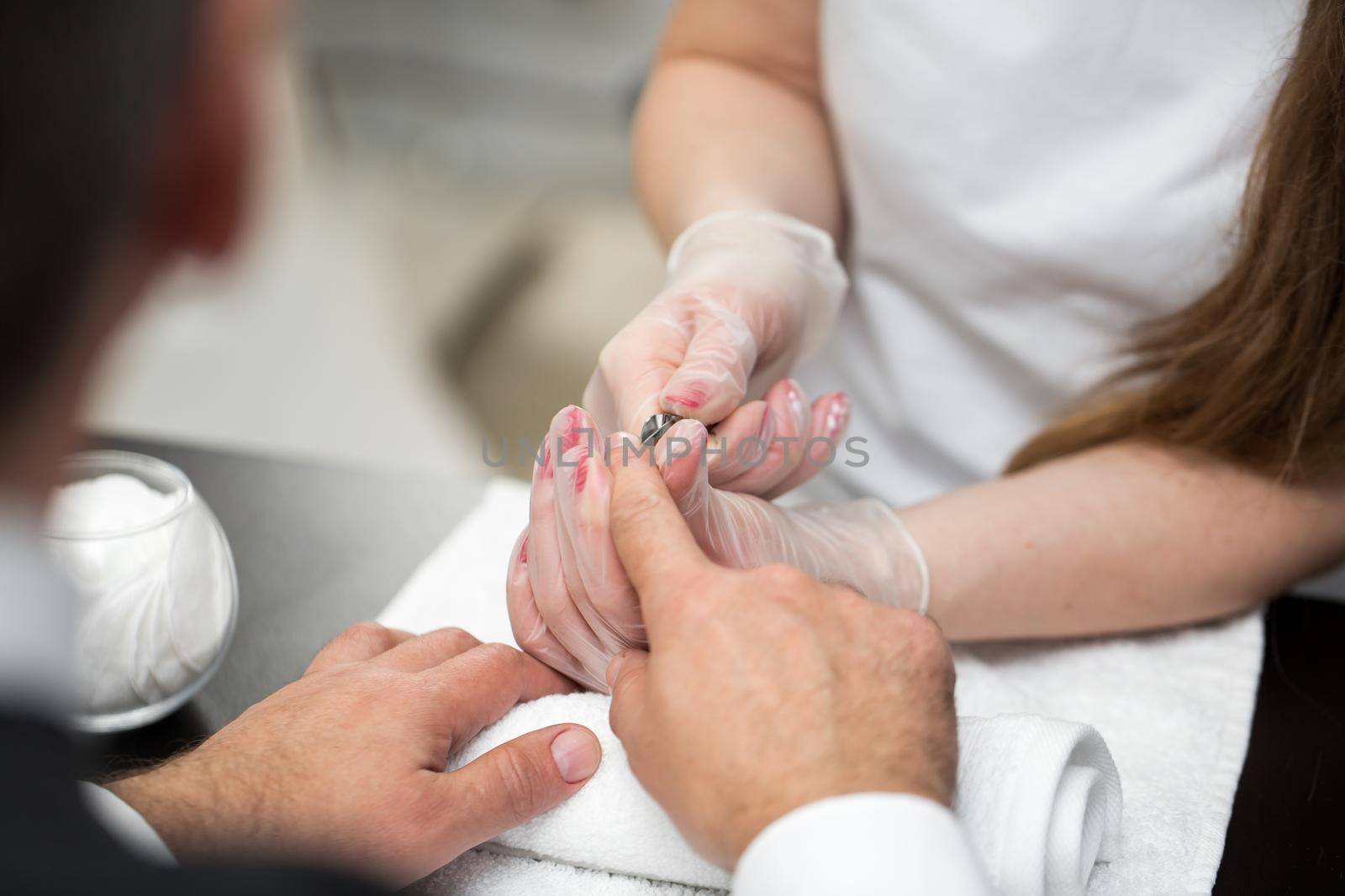 Close-up Of A Manicurist Cutting Off The Cuticle From The Person's Fingers