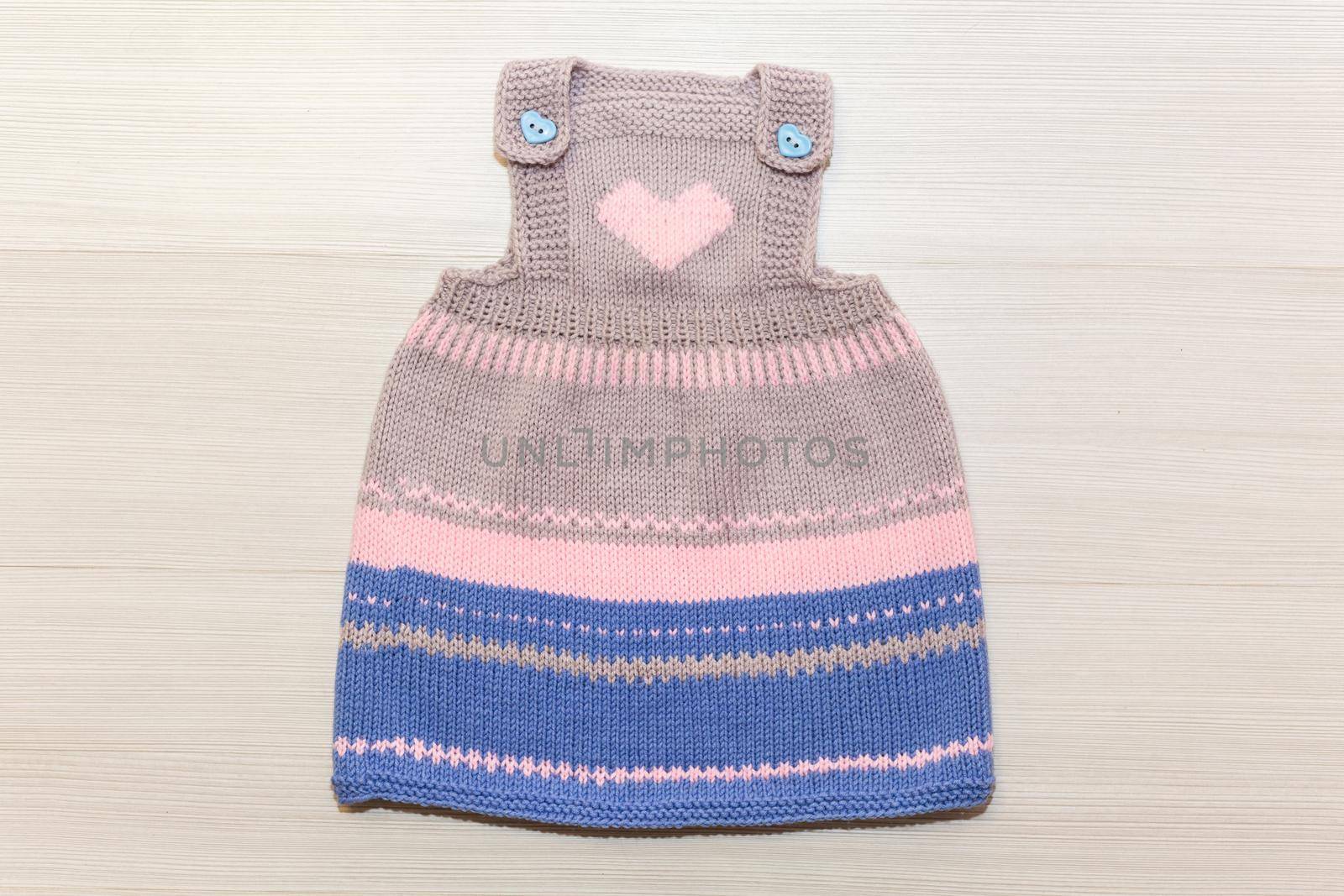Knitted wool dress for a child on a white background