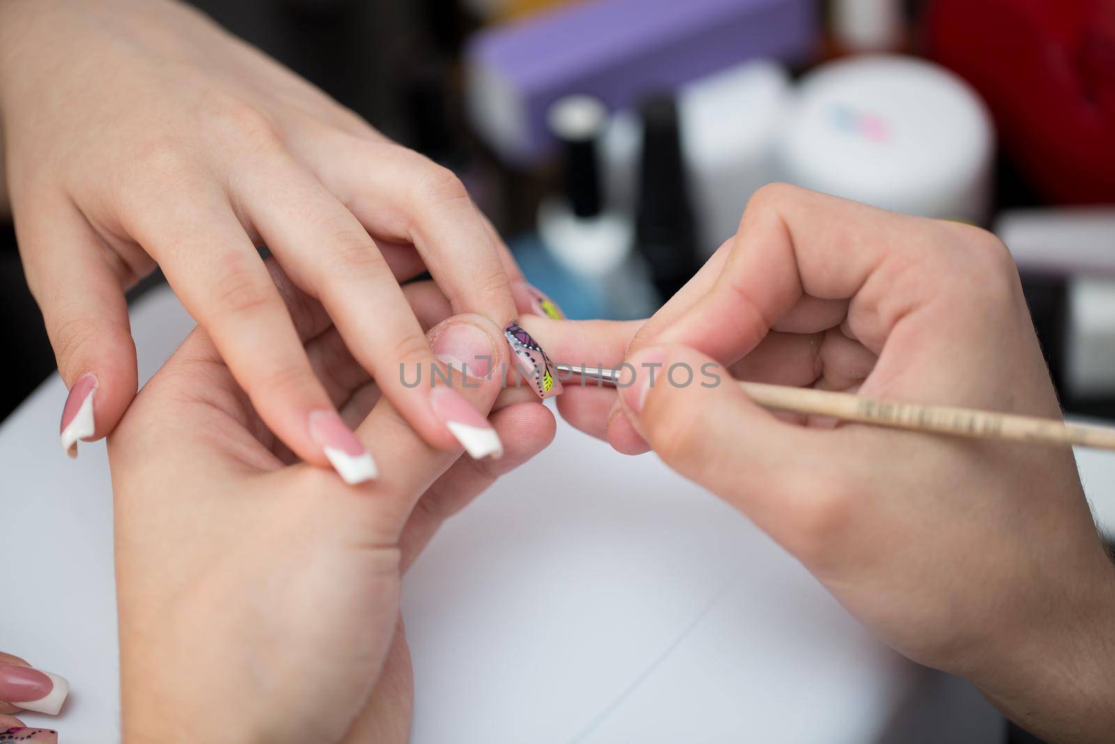 Closeup shot man making manicure to woman in beauty salon
