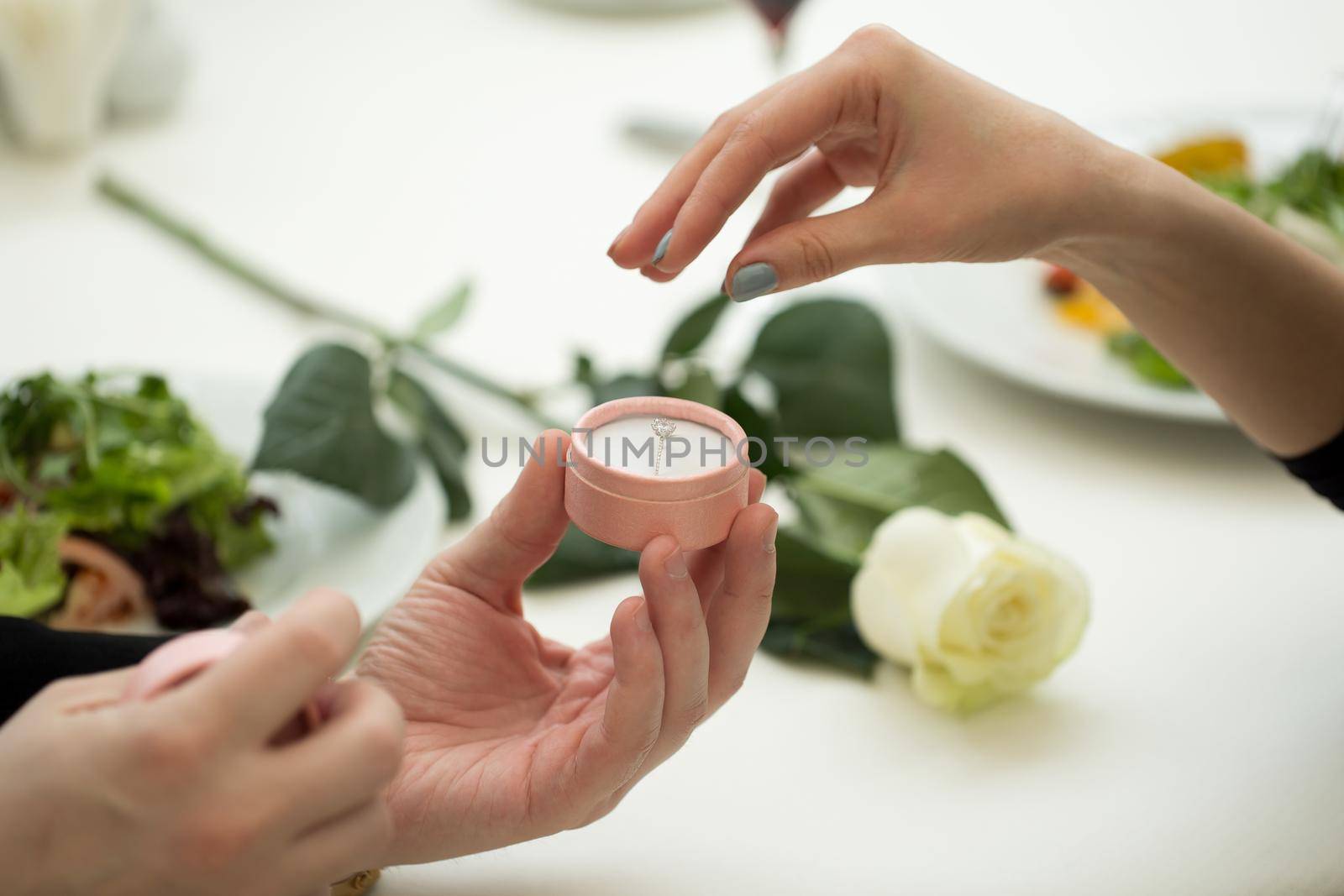 Man making marriage proposal to girlfriend at restaurant, closeup. by StudioPeace