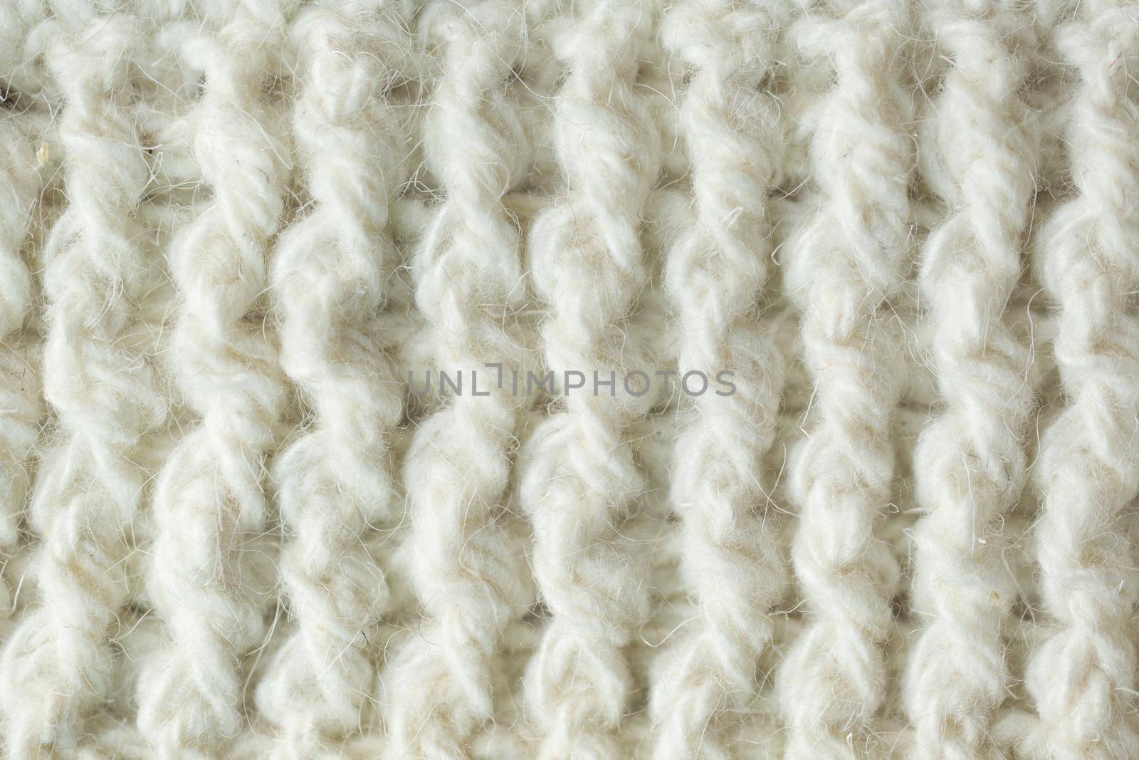 Knit texture of white wool knitted fabric with cable pattern as background by StudioPeace