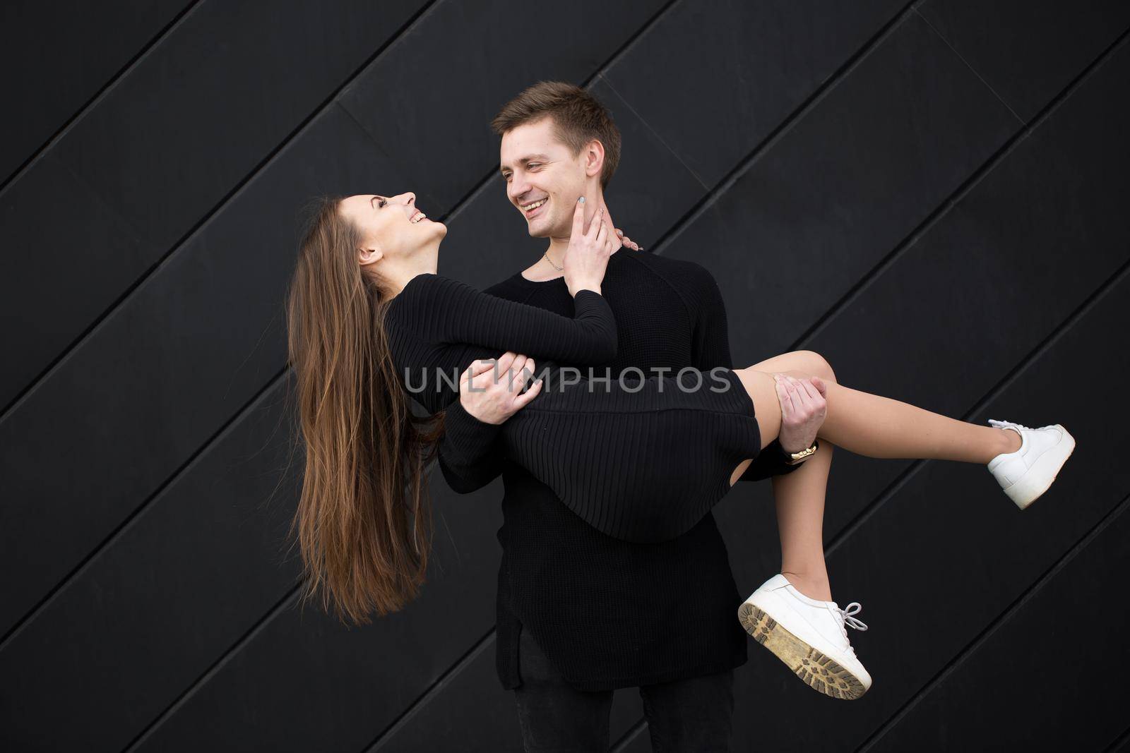 Man holding woman hands on black background