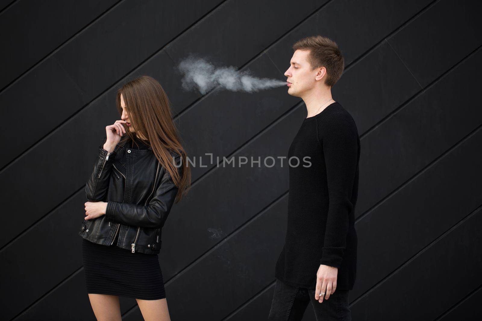 Passive smoking concept. Woman is covering her face from cigarette smoke