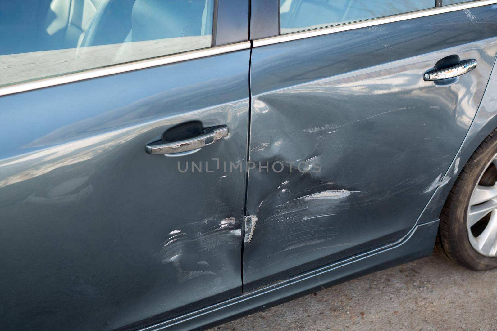 Sheet metal damage on a blue car after an accident. by StudioPeace