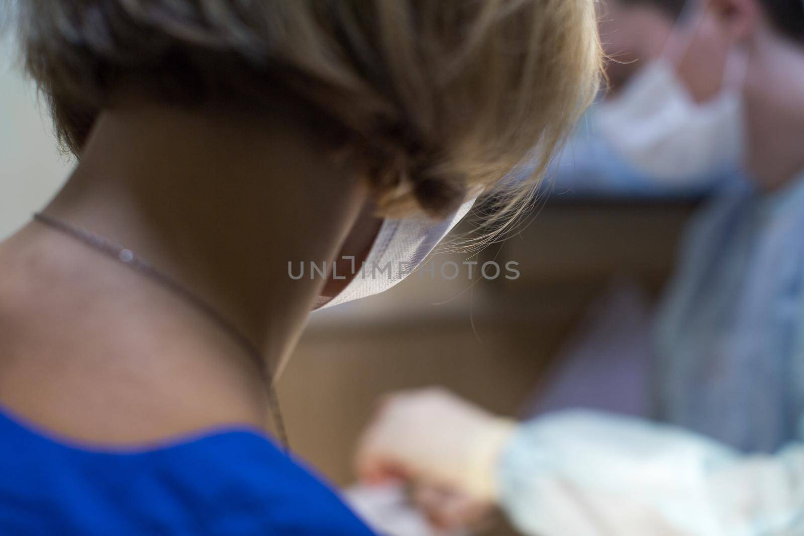 Two veterinarians perform surgery on an animal