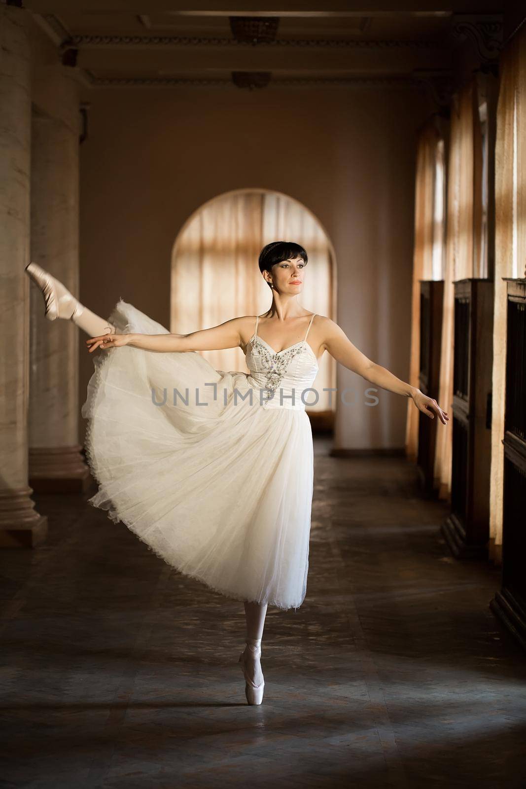 Adult ballerina practicing in the hall of the theatre