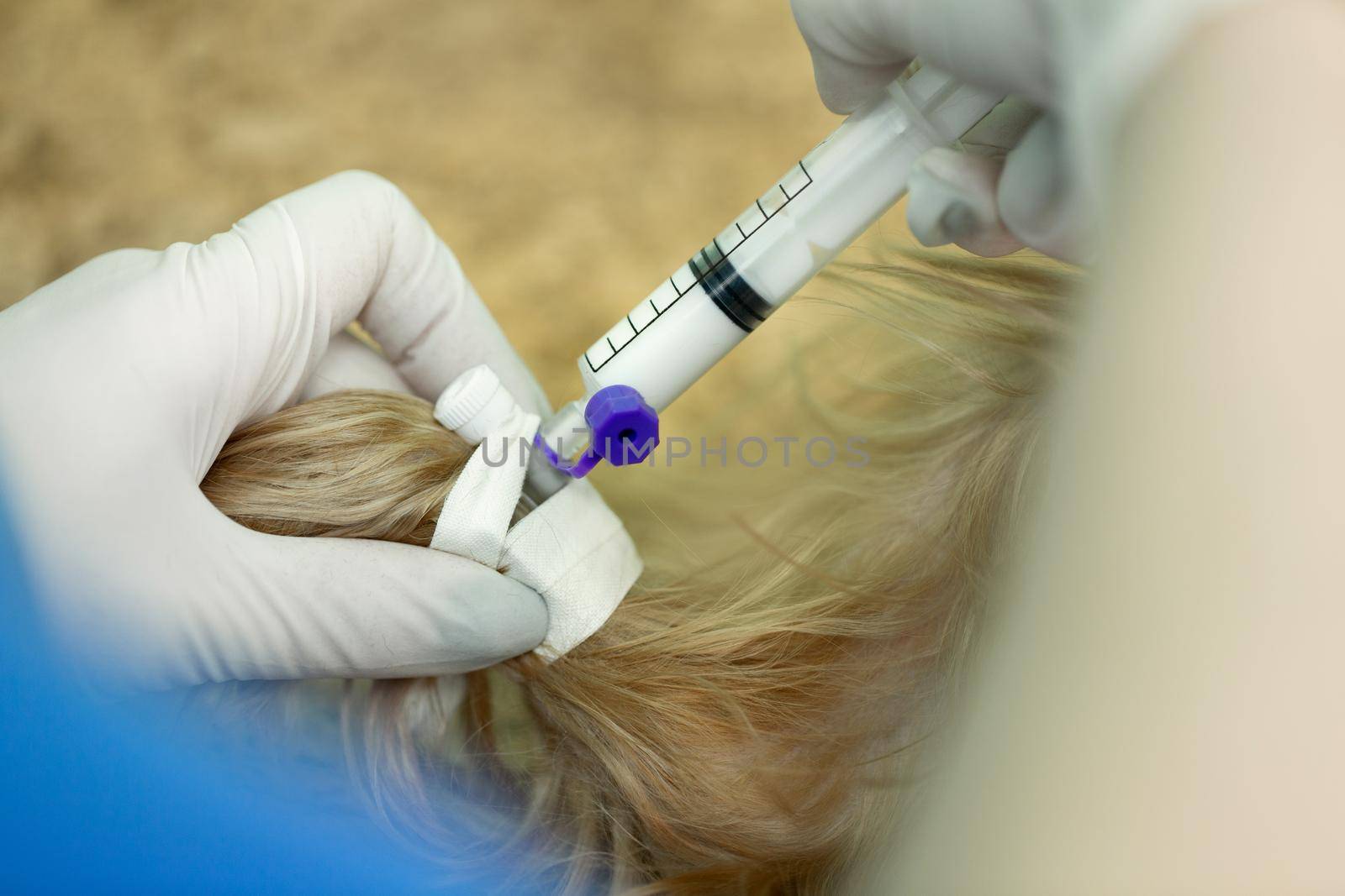 Close up veterinarian giving an injection to a dog at hospital. by StudioPeace