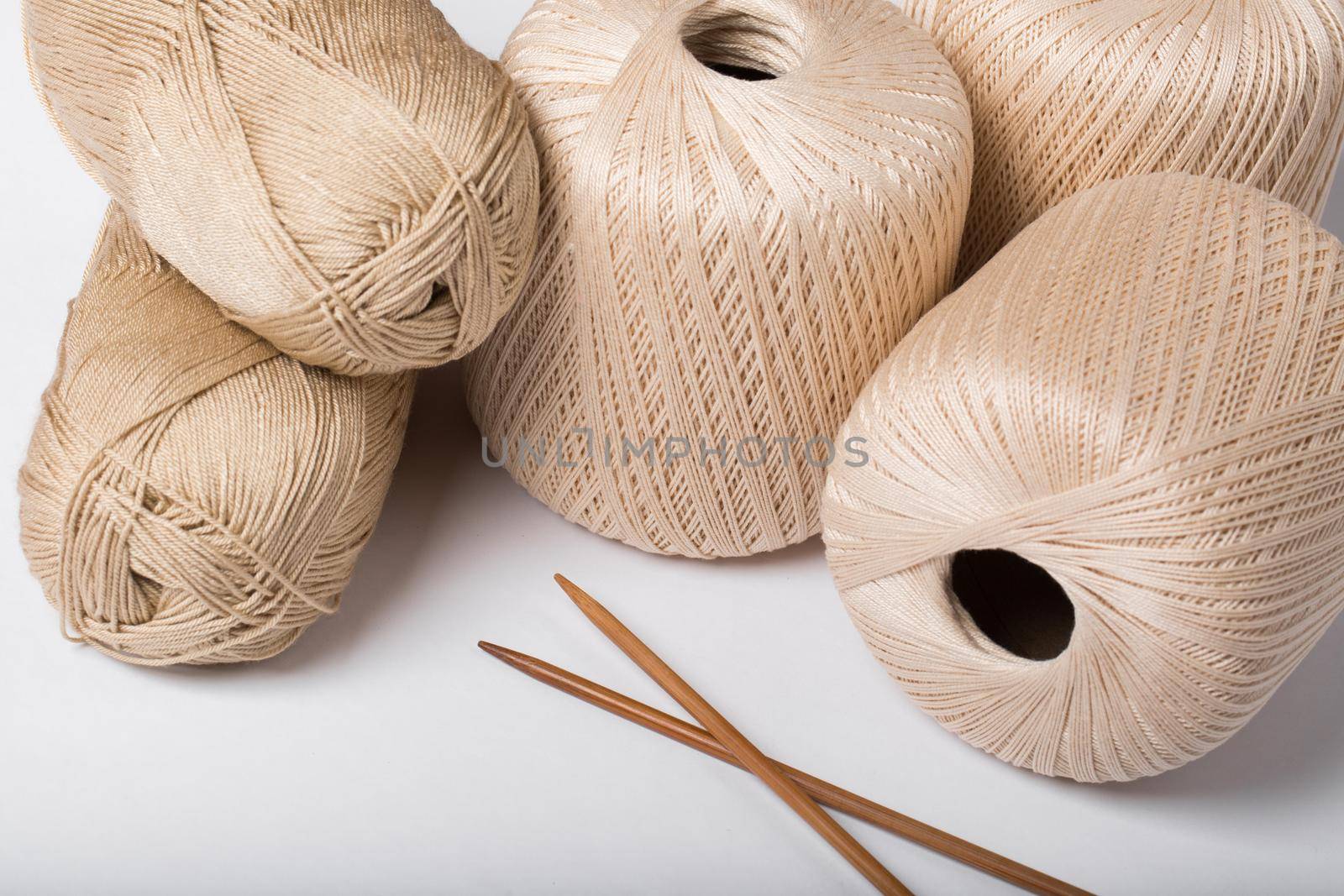 Woolen threads with spokes for knitting isolated on white background