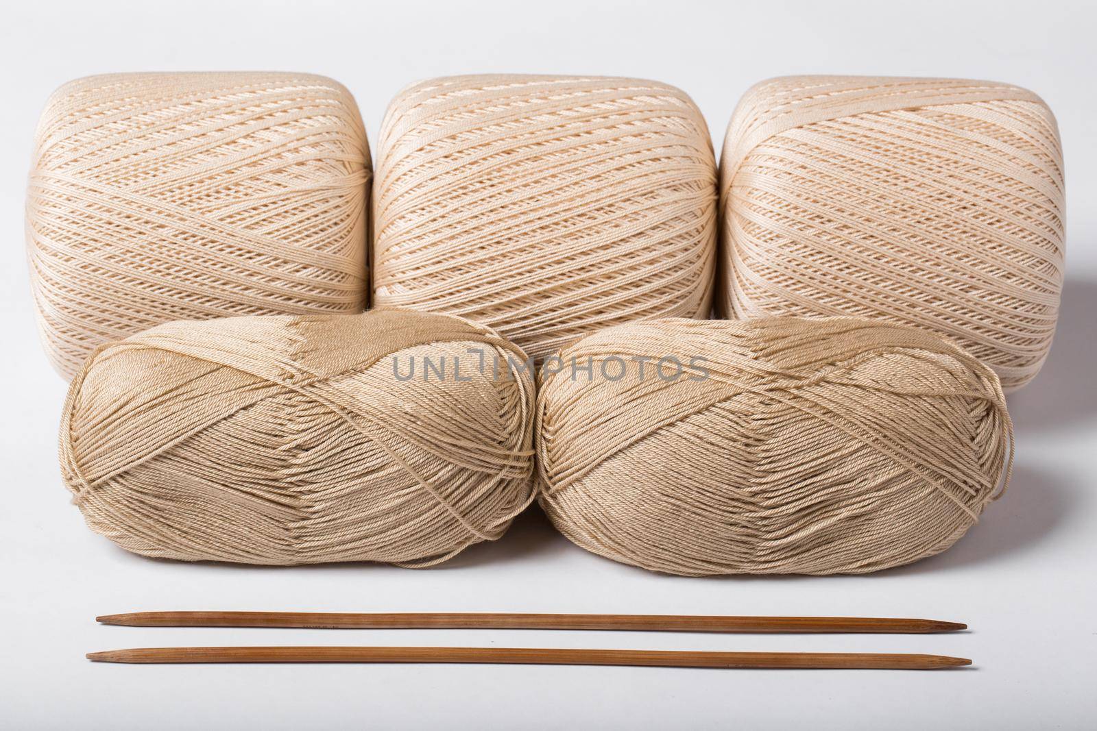 Woolen threads with spokes for knitting isolated on white background by StudioPeace