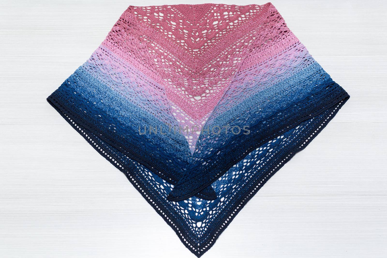 Knitted scarf pink and blue on a white background