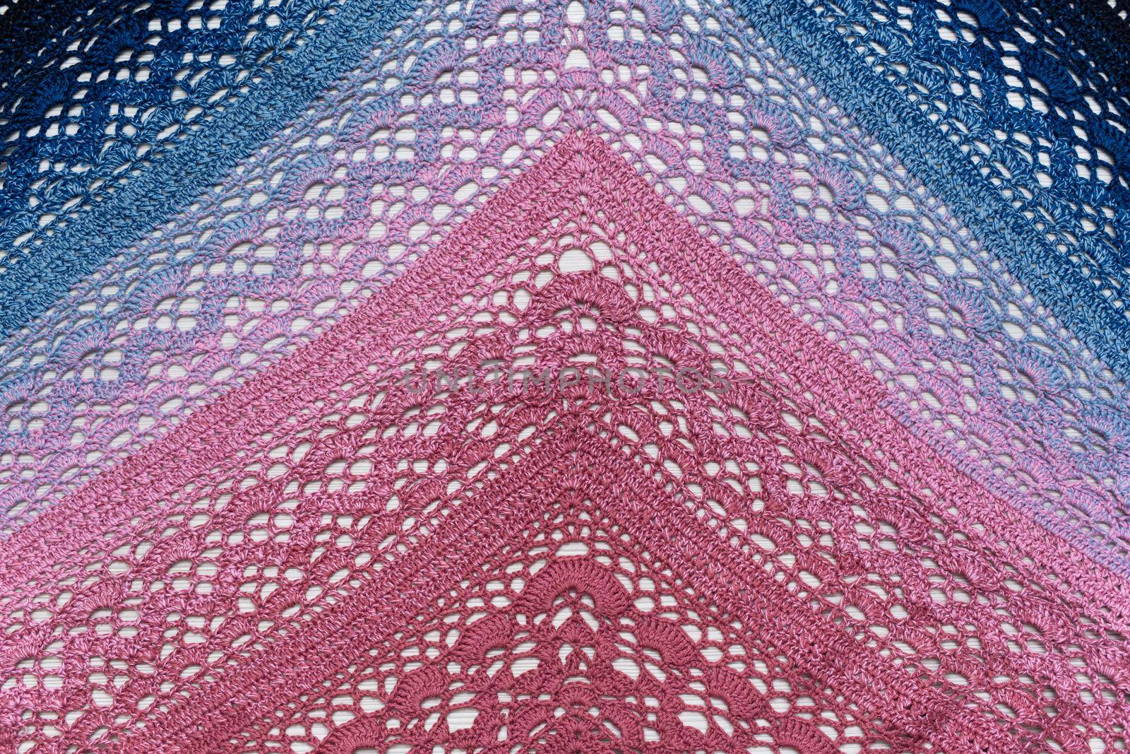 Knitted scarf pink and blue on a white background