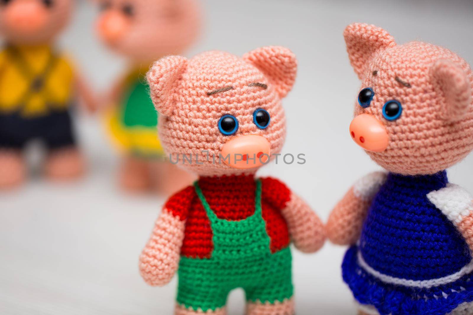 Knitted piglets toys for a child. A symbol of the New Year.