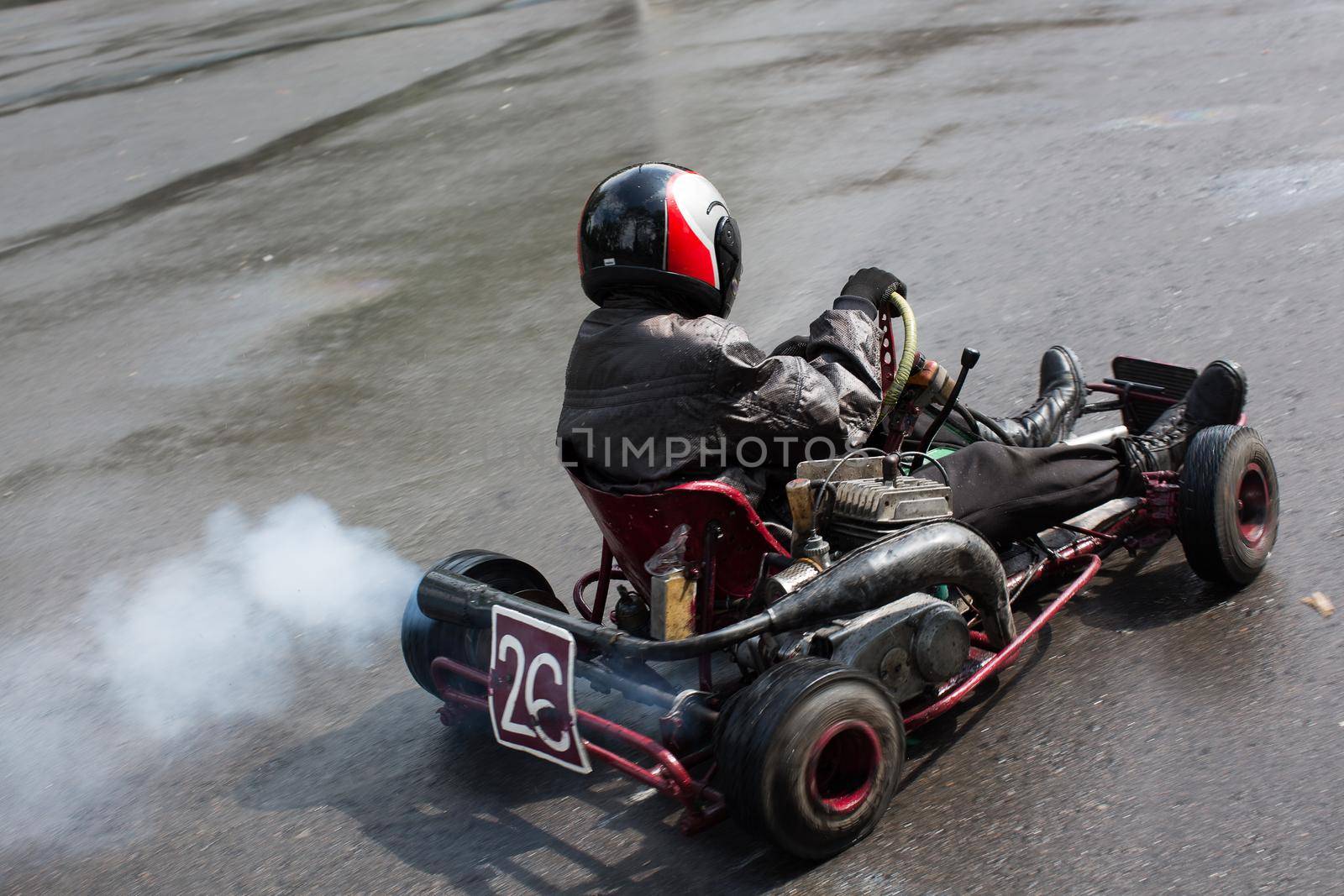 Karting - driver in helmet on kart circuit