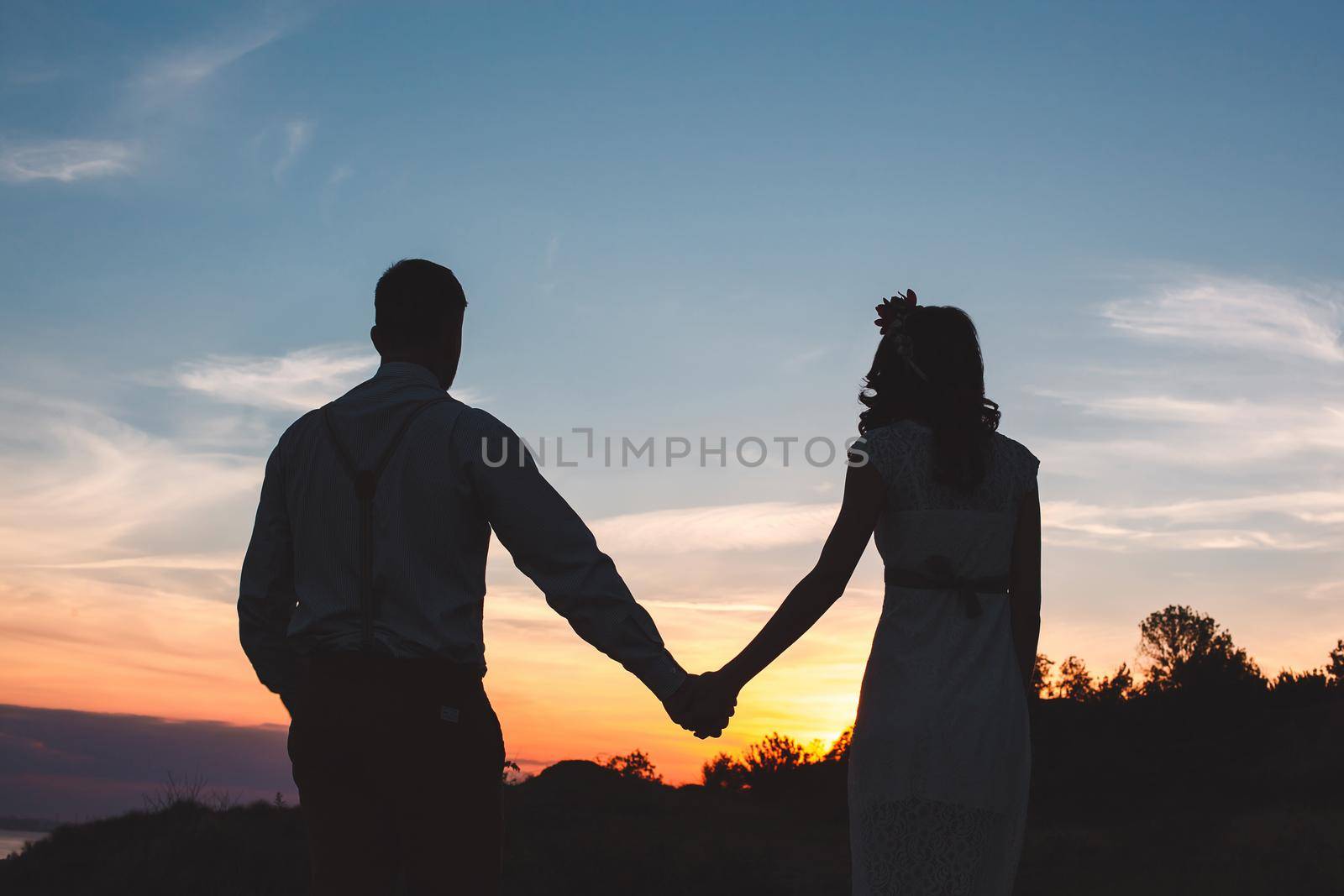 Loving couple together outdoor in mountains over scenic sunset sky background by StudioPeace