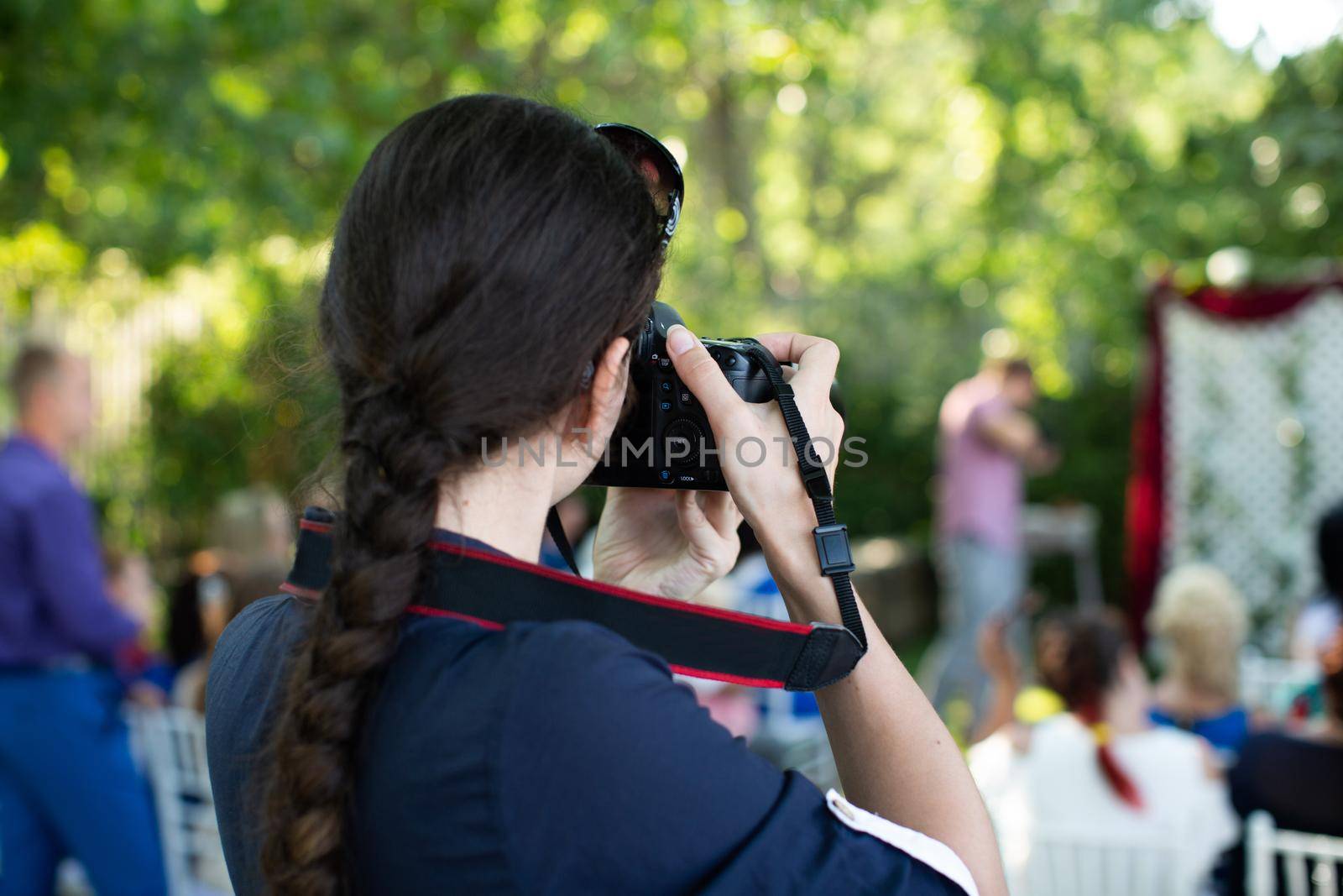 Photographer is a woman photographing a wedding ceremony. by StudioPeace