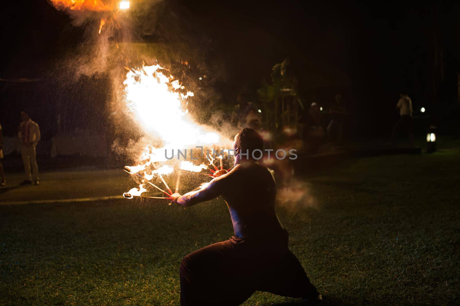 Fire show artist breathe fire in the dark. by StudioPeace
