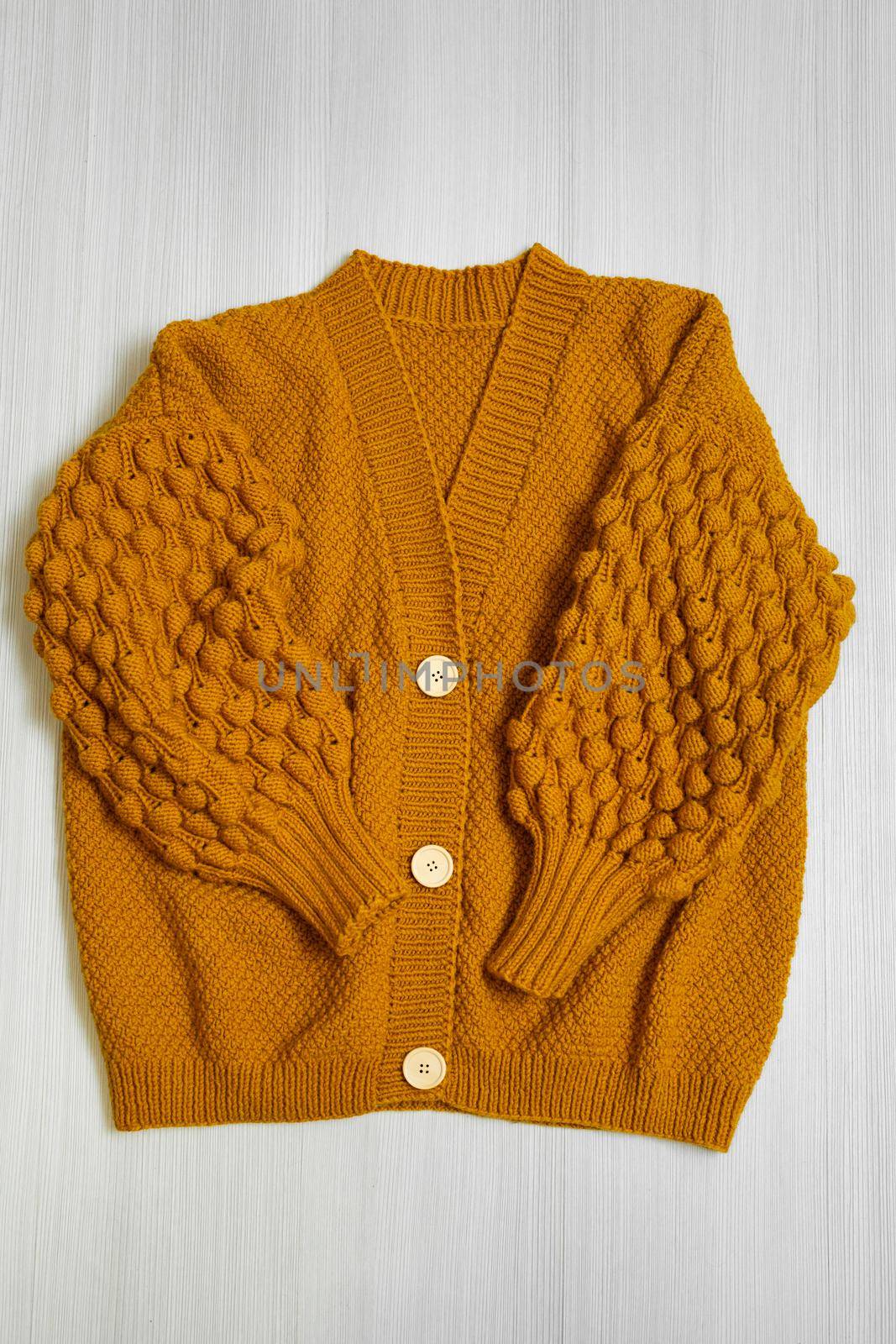 Knitted children's sweater on a white background. by StudioPeace