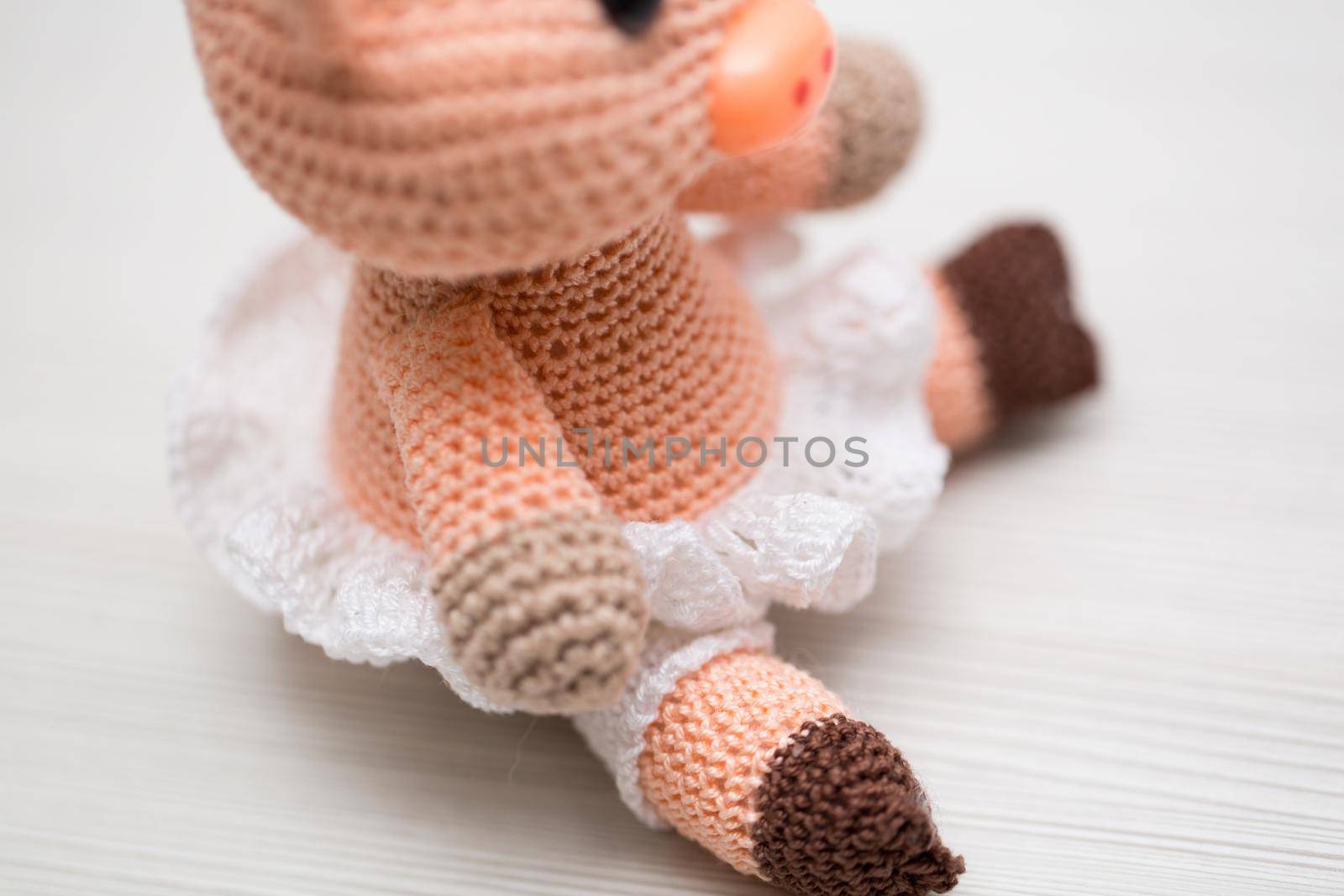 A knitted pig toy for a child. Symbol of the New Year