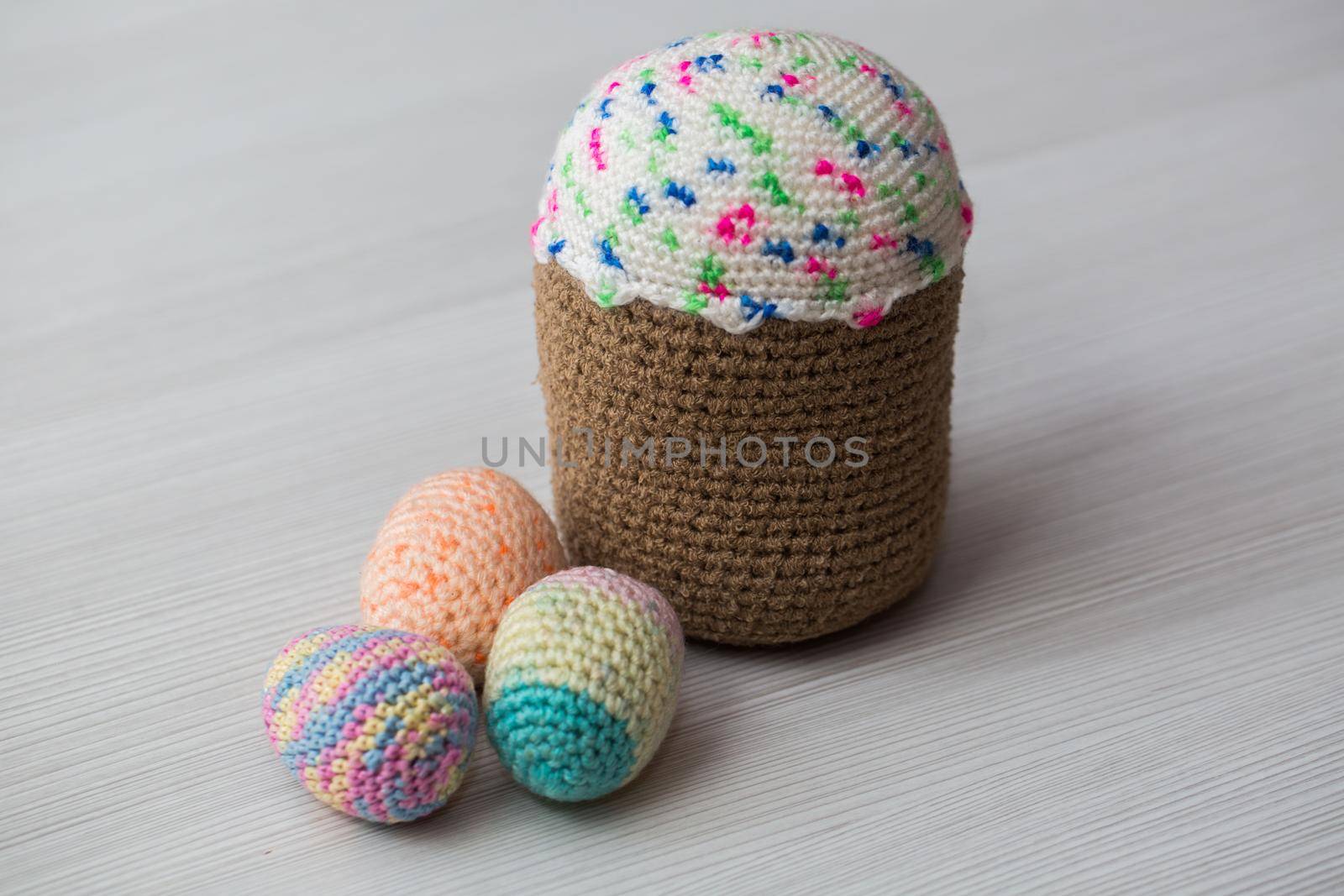 Knitted Easter eggs, chicken, cock on a white table. by StudioPeace