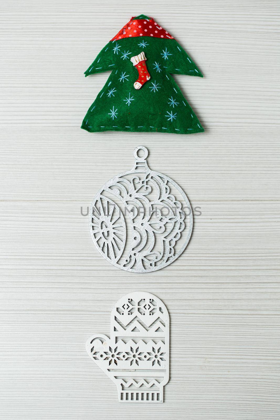 Christmas, new years decor on a wooden white background. Tree, glove, ball by StudioPeace