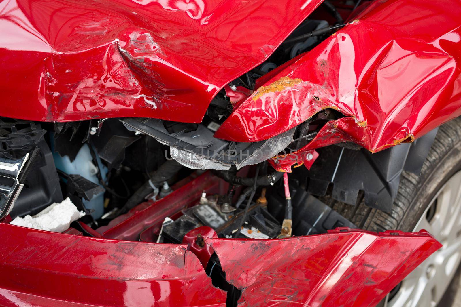 Red Car crash background. Front of red car get damaged by accident on the road