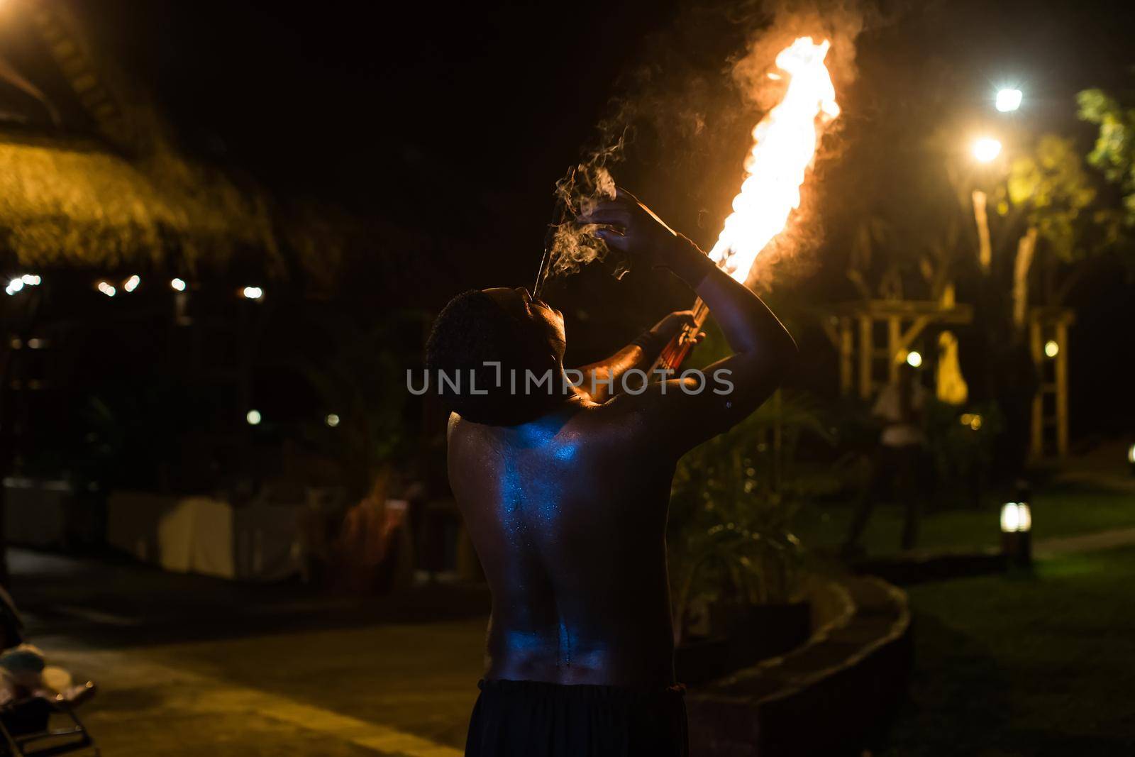 Fire show artist breathe fire in the dark