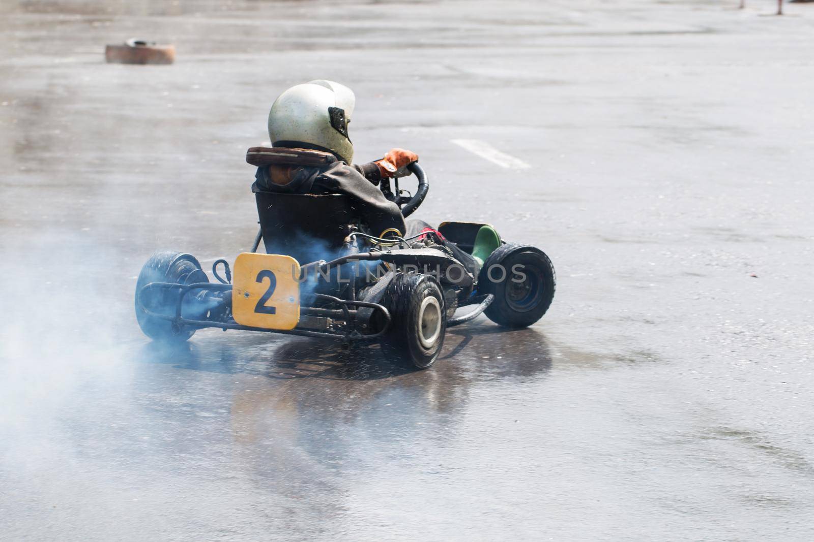 Karting - driver in helmet on kart circuit. by StudioPeace