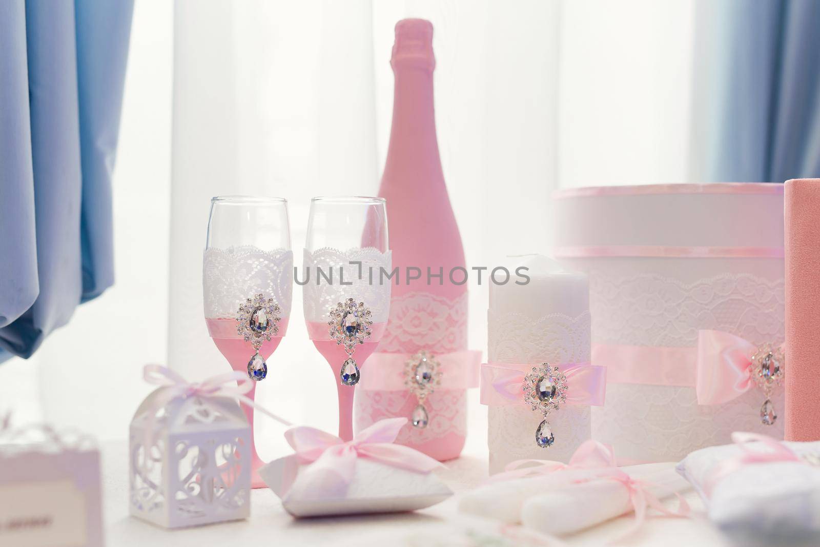 Wedding glasses and a bottle of champagne at the exhibition. by StudioPeace