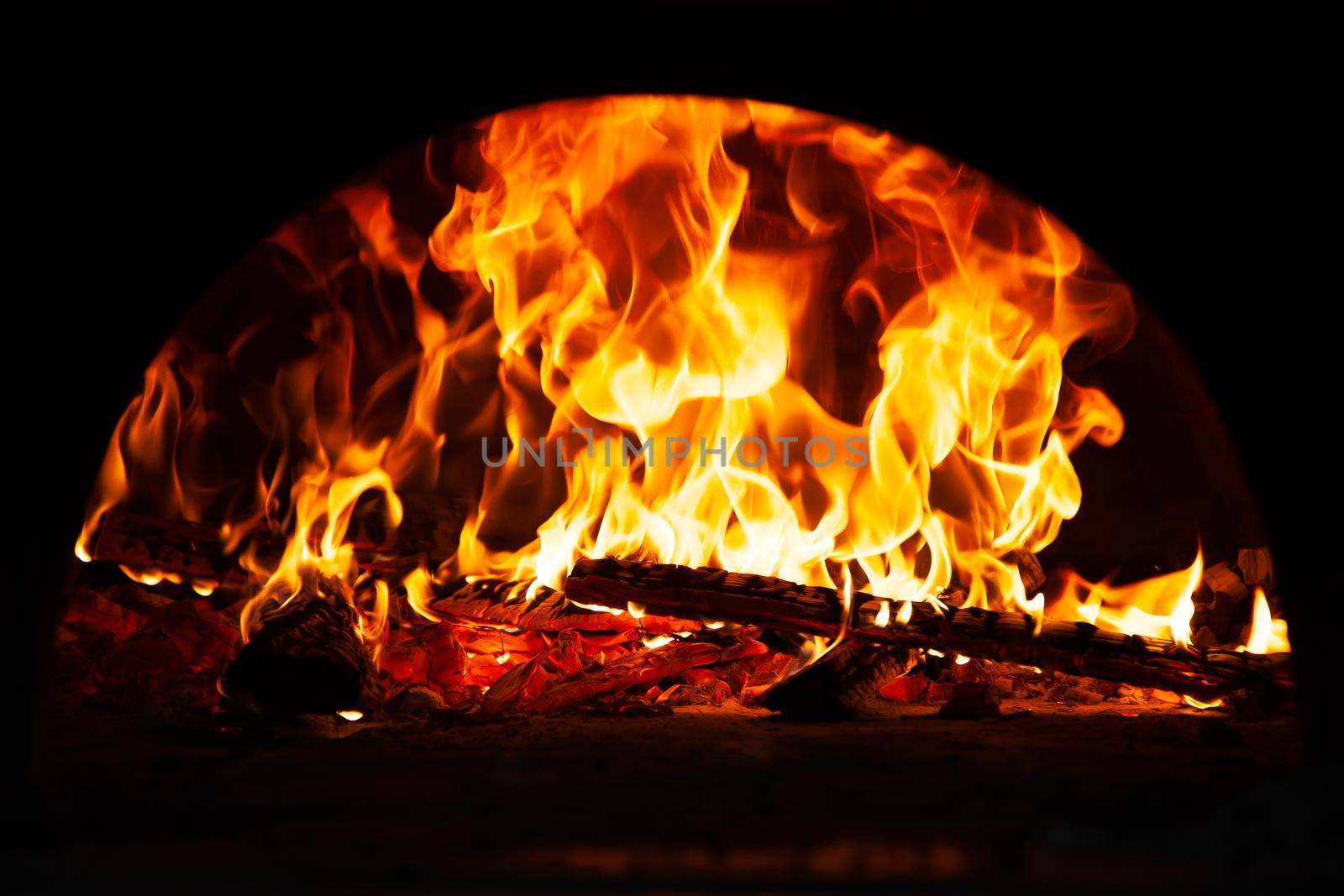 Hot flame of fire in oven. Warm evening by the fireplace