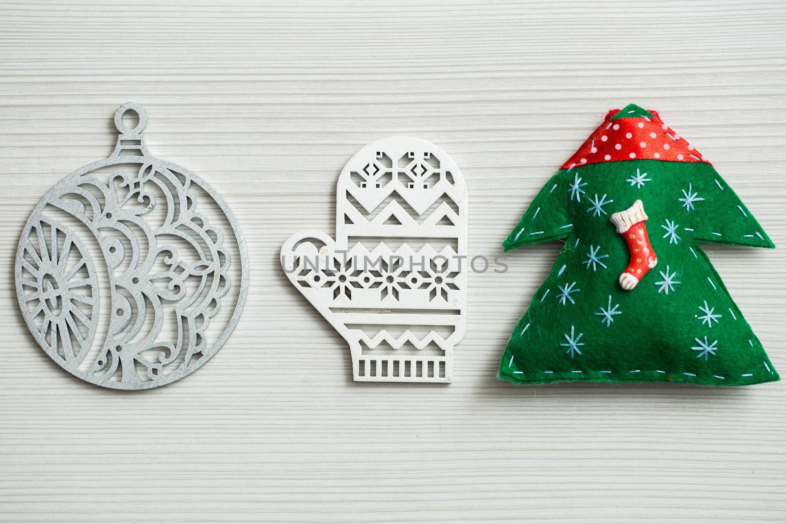 Christmas, new years decor on a wooden white background. Tree, glove, ball by StudioPeace