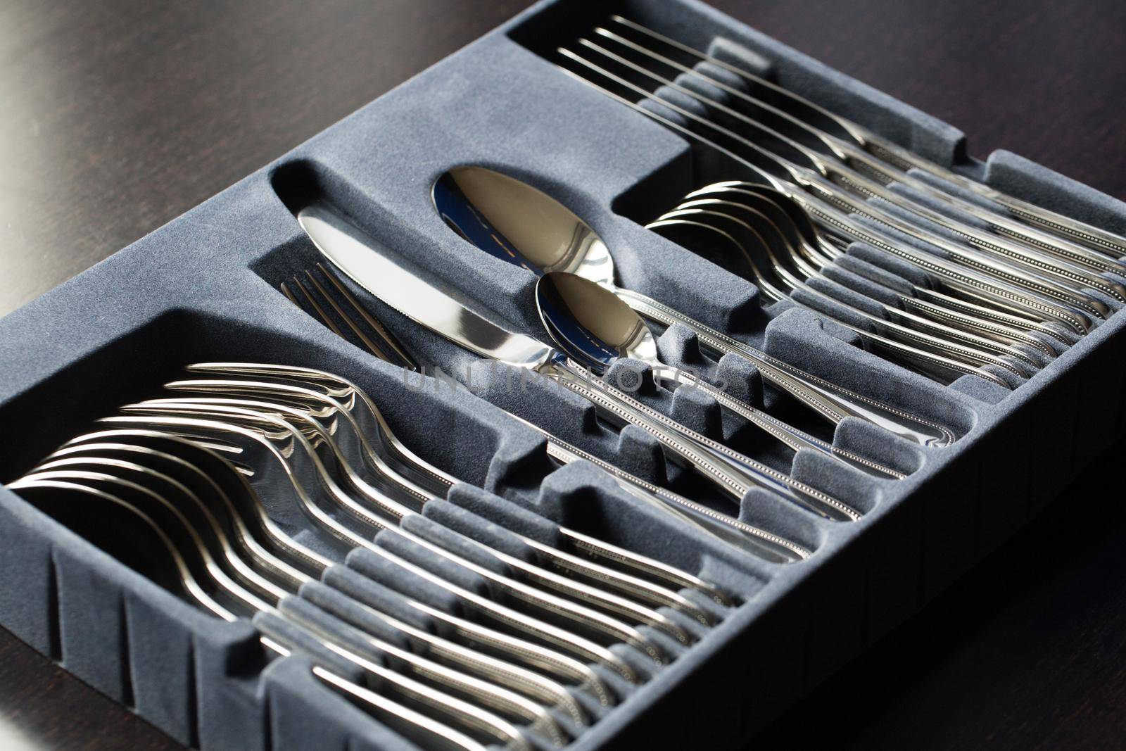 Blue flatware box isolated on black background. by StudioPeace