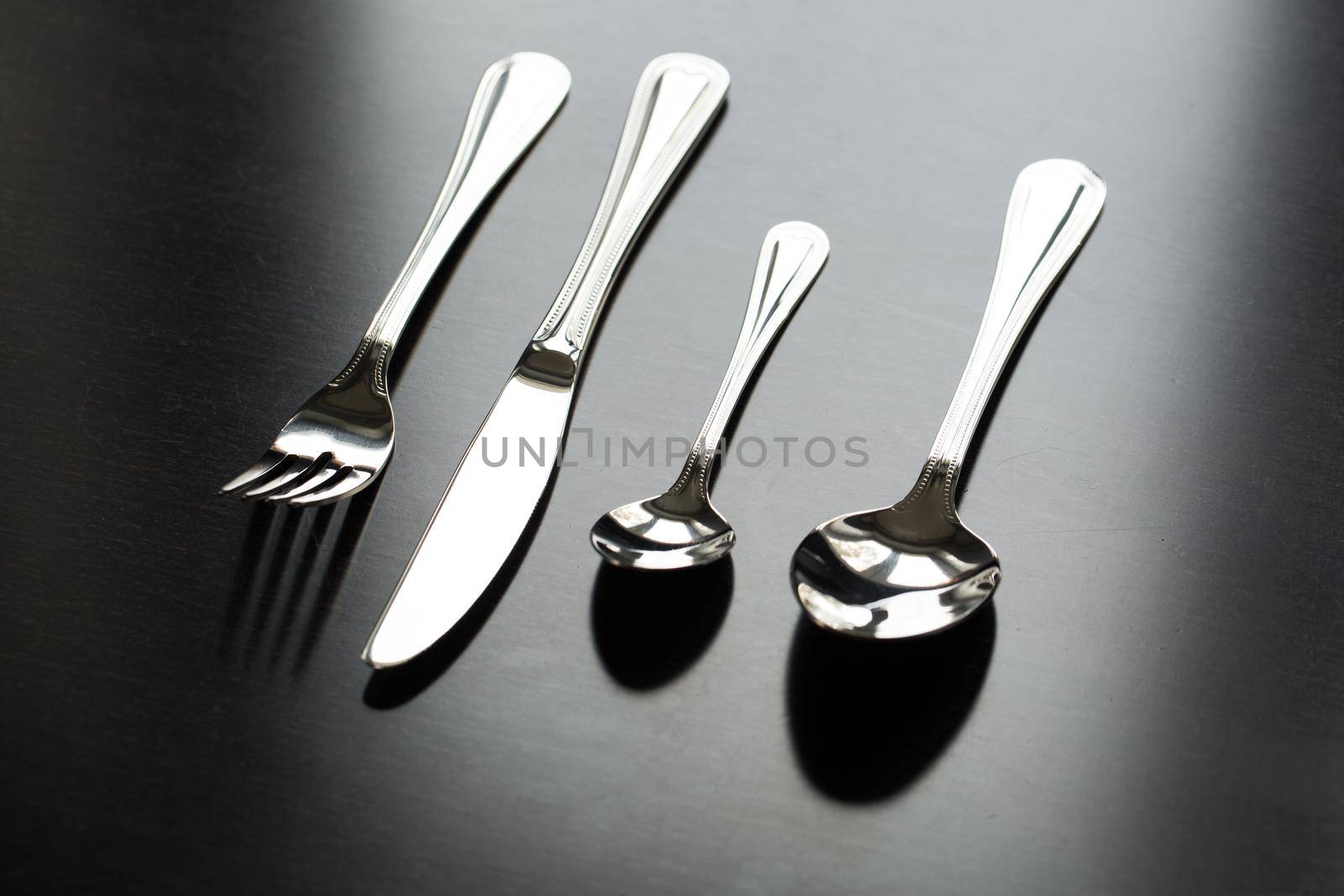 Cutlery on a black background. Fork, spoon knife