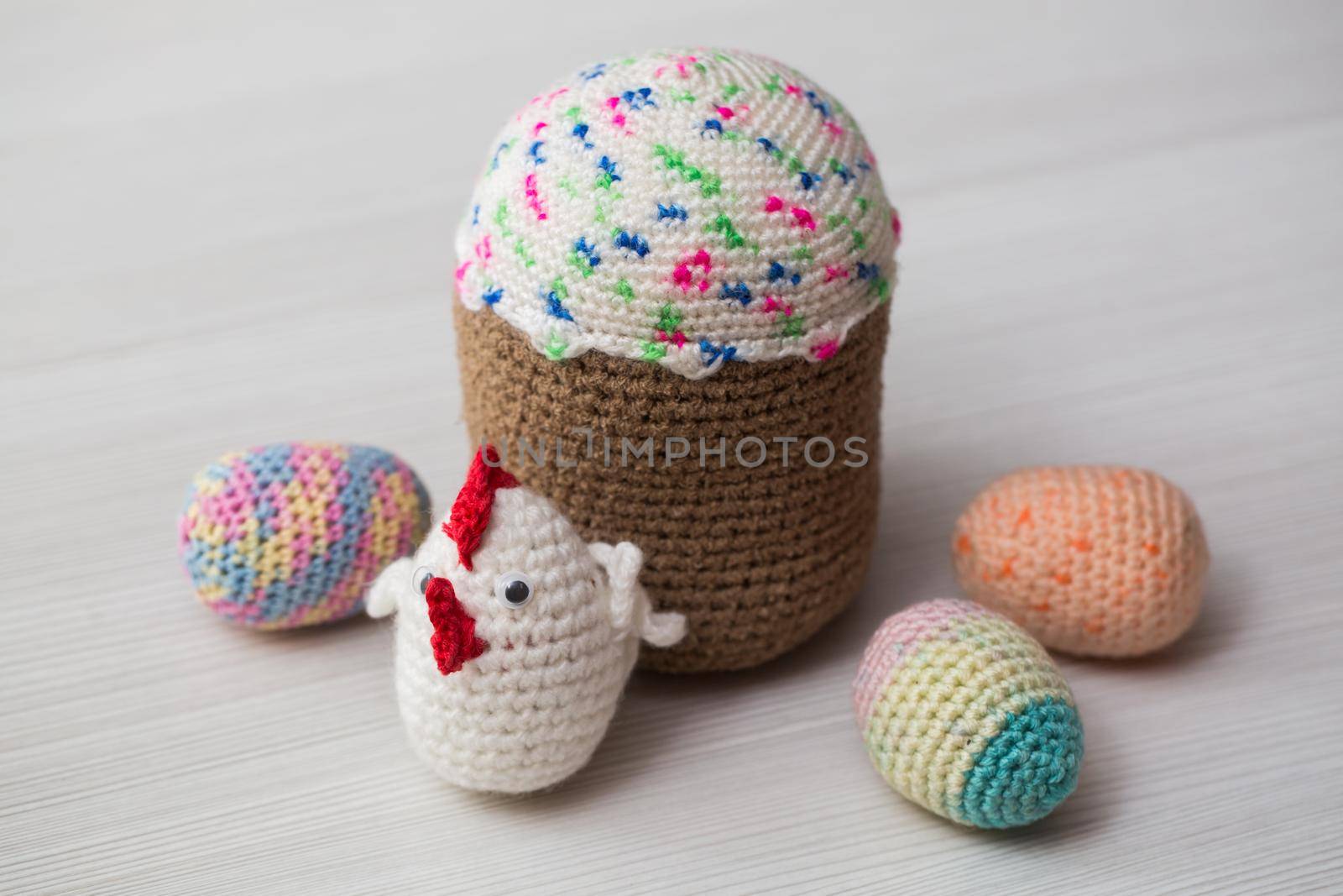 Knitted Easter eggs, chicken, cock on a white table. by StudioPeace