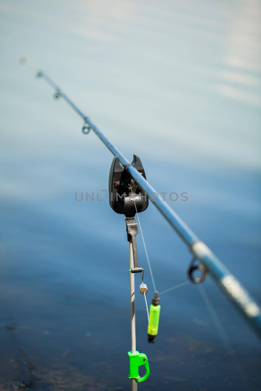 Freshwater fishing with fishing rods on the shore of the pond, lake