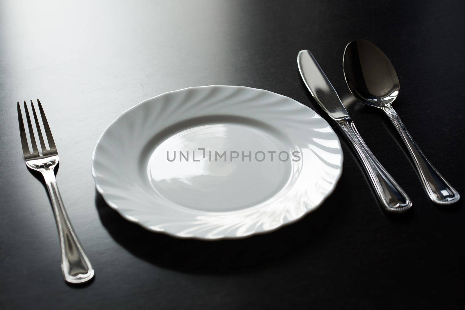 Cutlery on a black background. Fork, spoon, knife, plate by StudioPeace