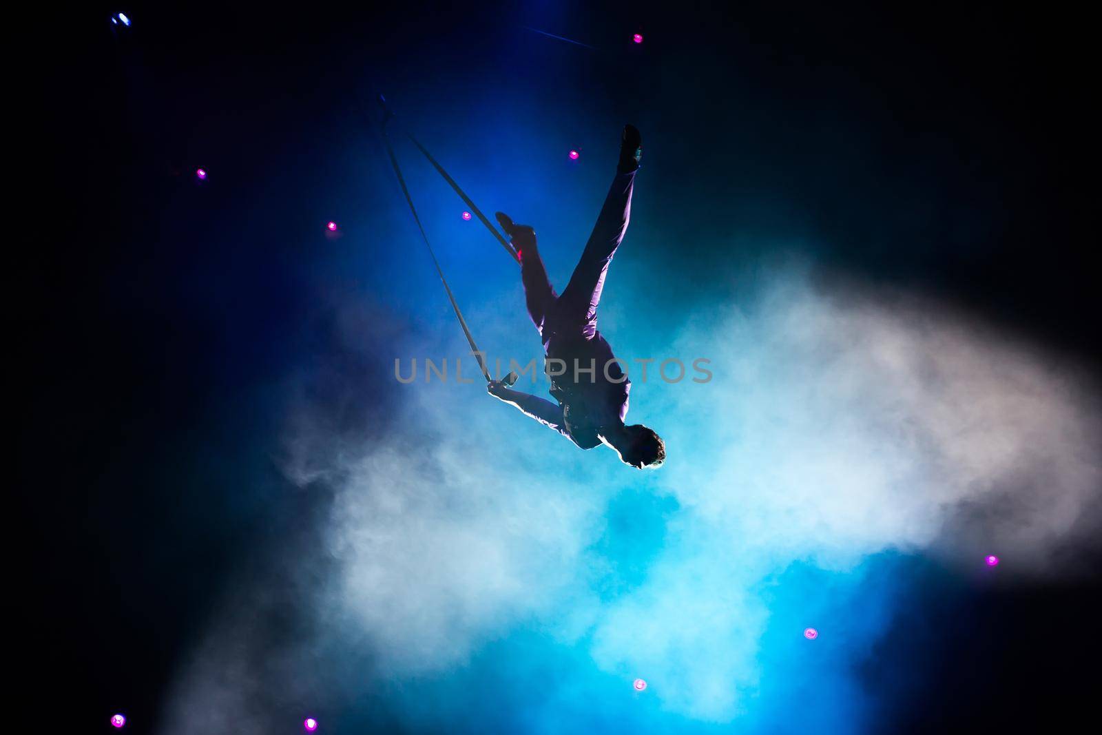 Circus. Air gymnasts on canvases. Cloths. Circus artists. Flight under the dome of the circus