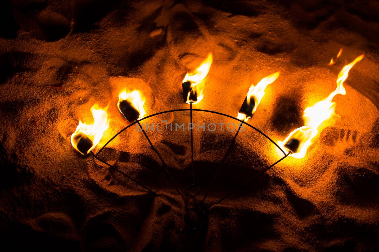 Fire Show Fire Movement. Fan of fire on the sand.