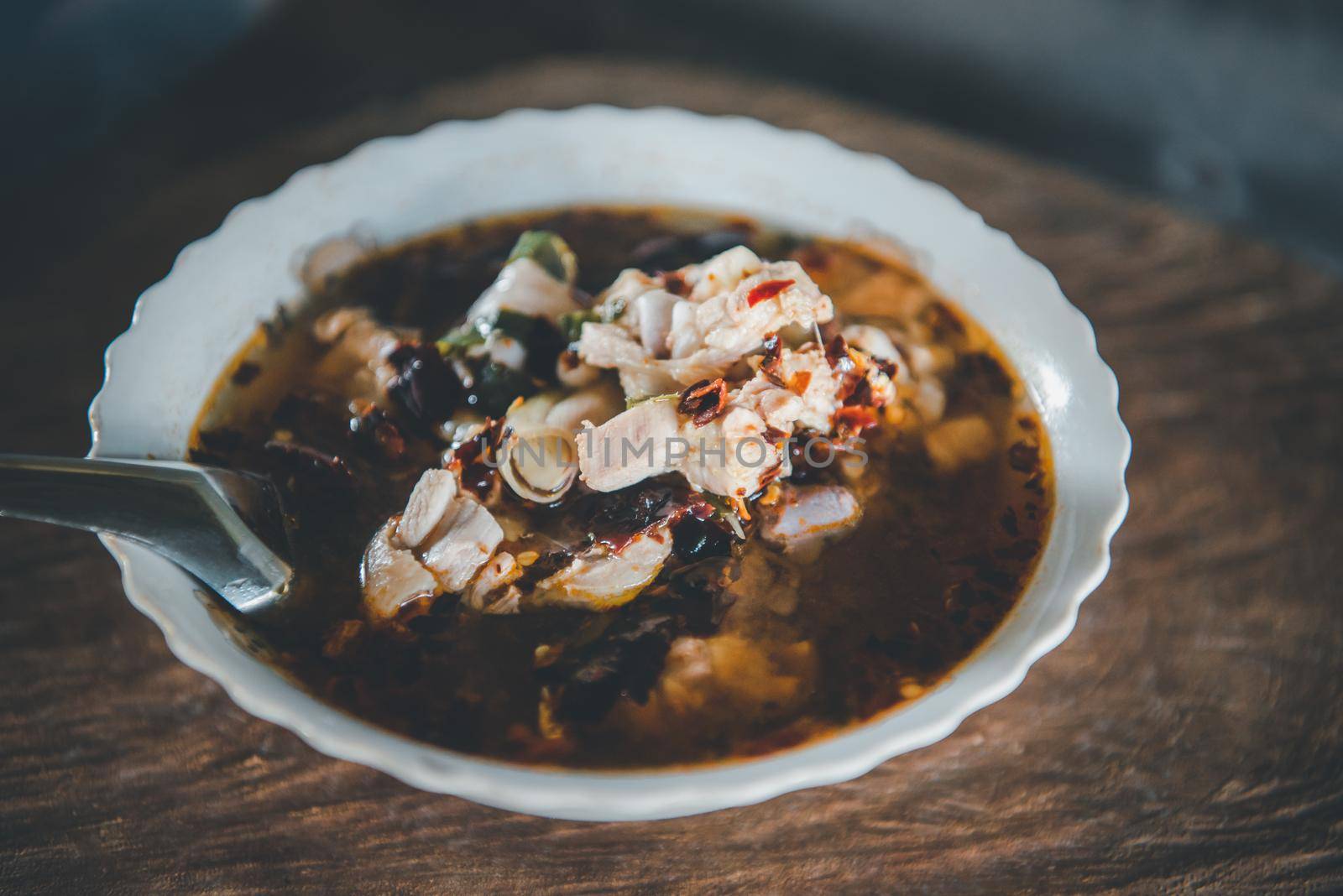 Hot and sour meat soup (Tom Yum) pork or chicken for sale at Thai street food market or restaurant in Thailand