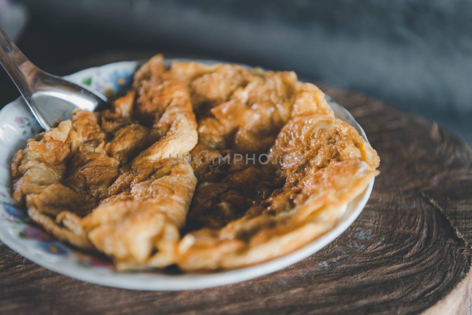 Thai style omelet is a Thai food make from egg cooking in pan with oil in Thai street food restaurant, healthy food concept