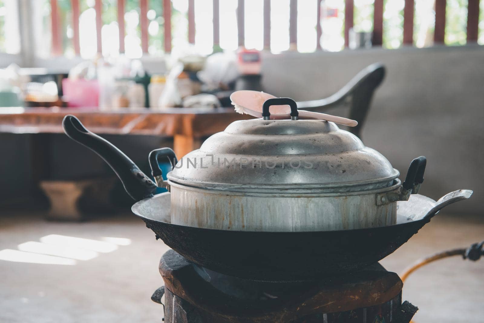 Thai traditional cooking steamer on pan and charcoal stove in Thai traditional kitchen