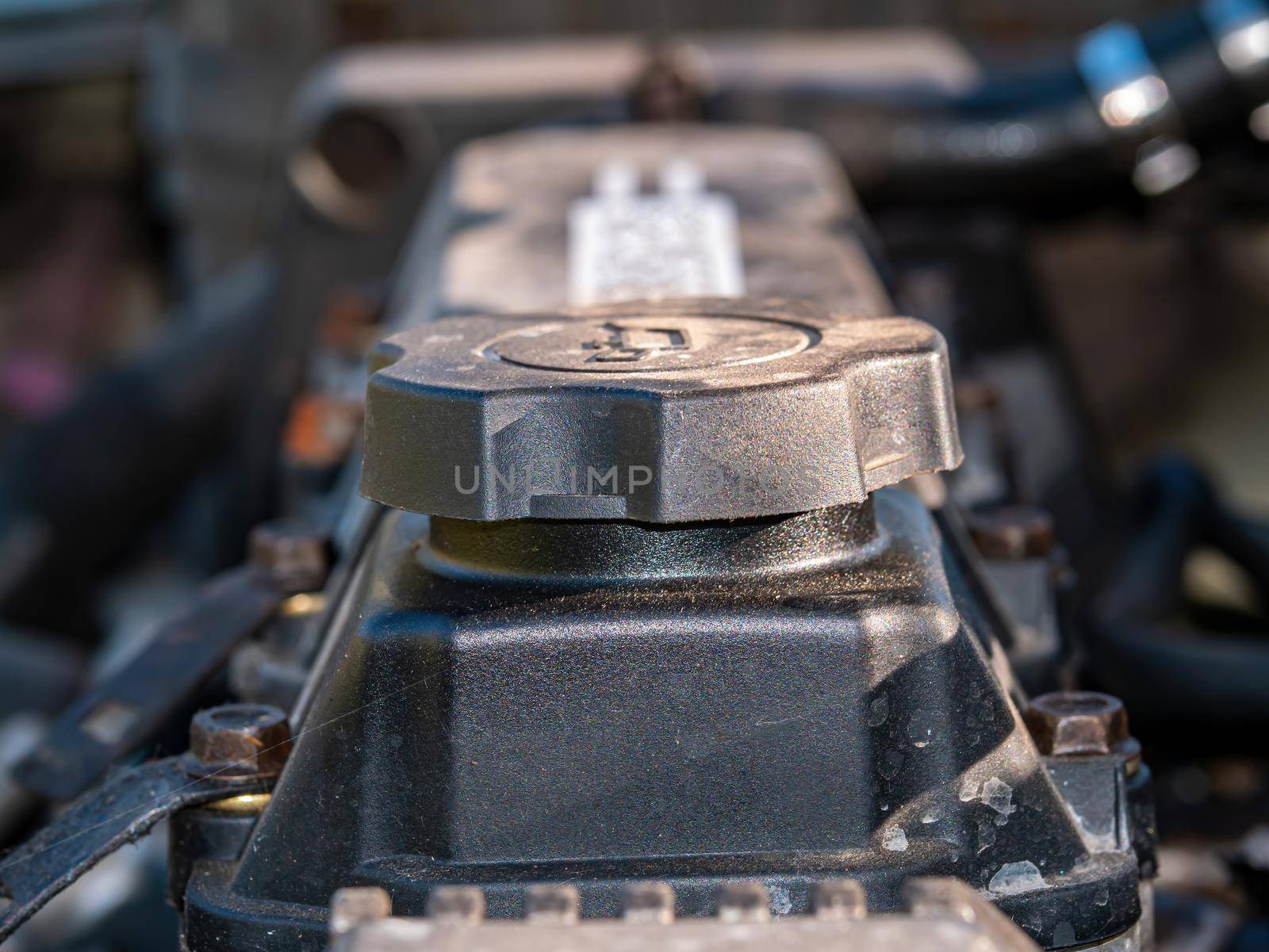 Filler cap for filling engine oil into a car engine. Engine oil filling point. Service service. Car maintenance and repair. Repair service workshop. Motor vehicle. Part of the car.