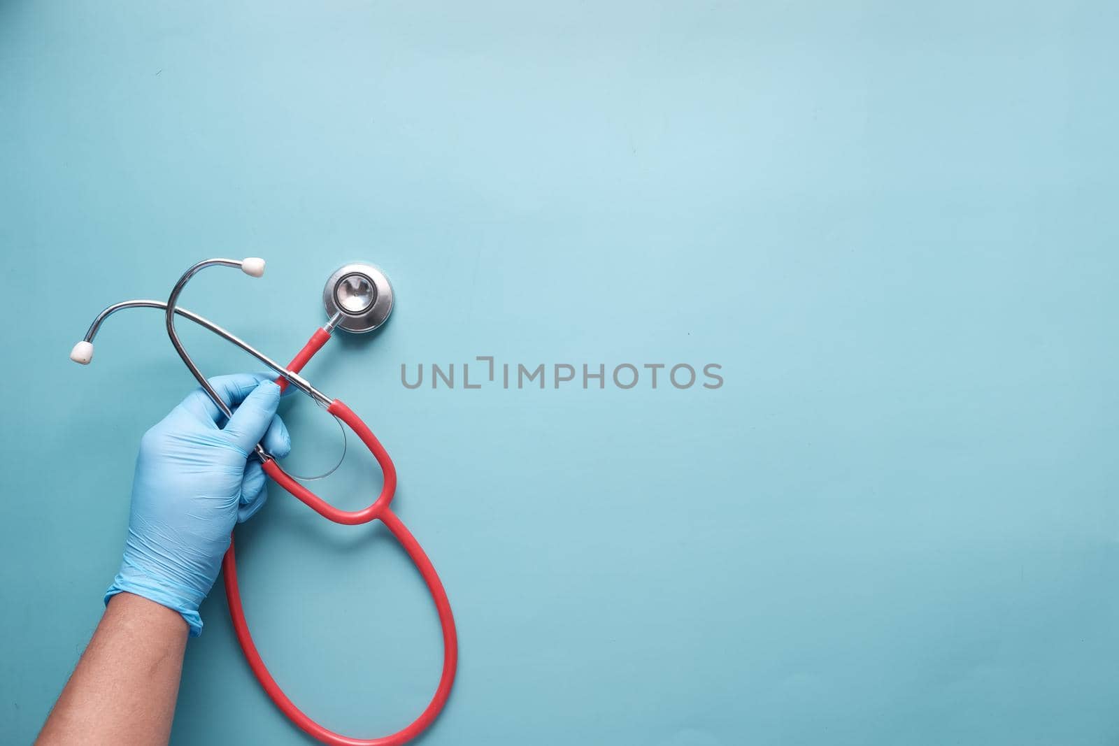 Close up of doctor hand using stethoscope