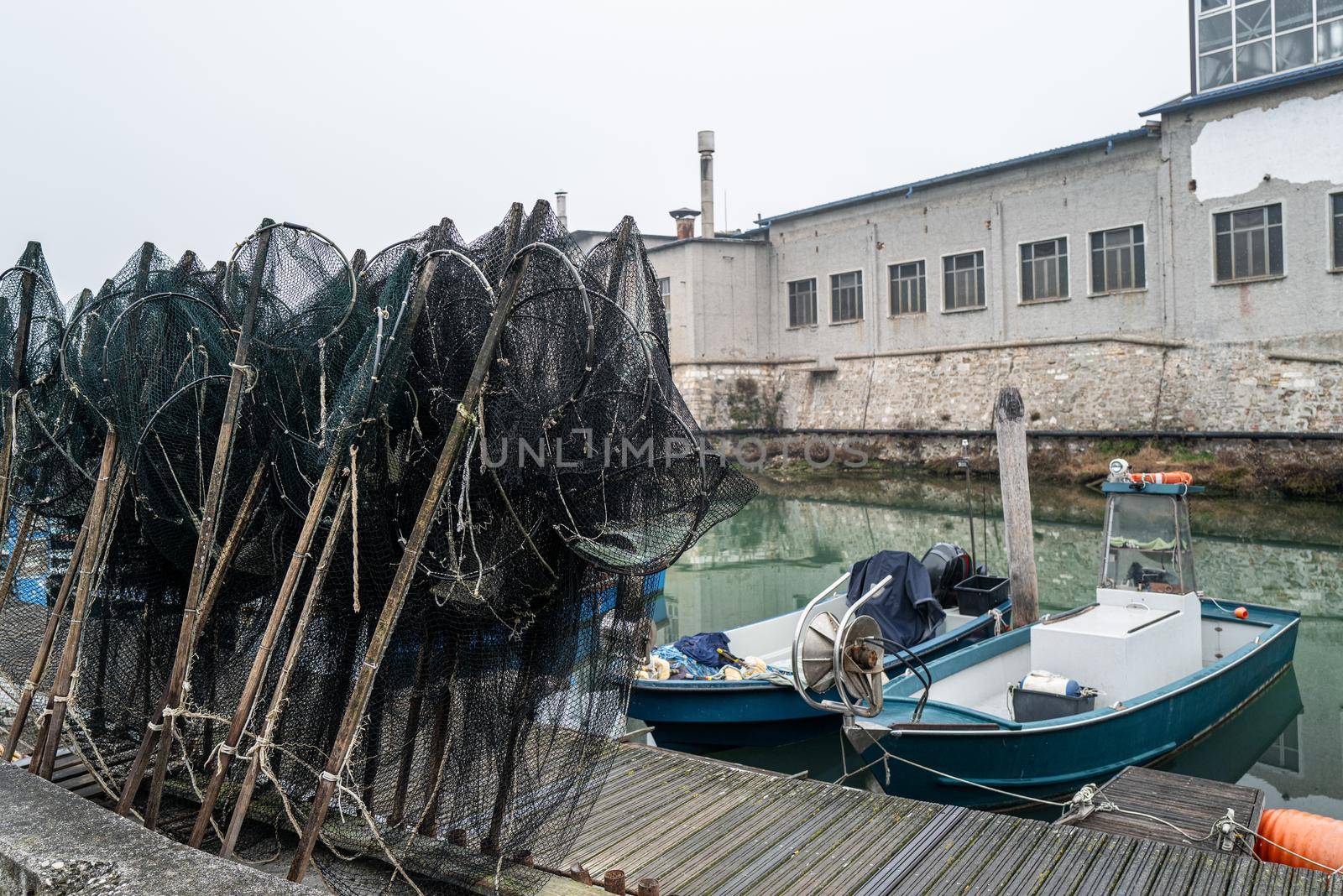Two small fishing boats and prepared creels in an old fishing port.