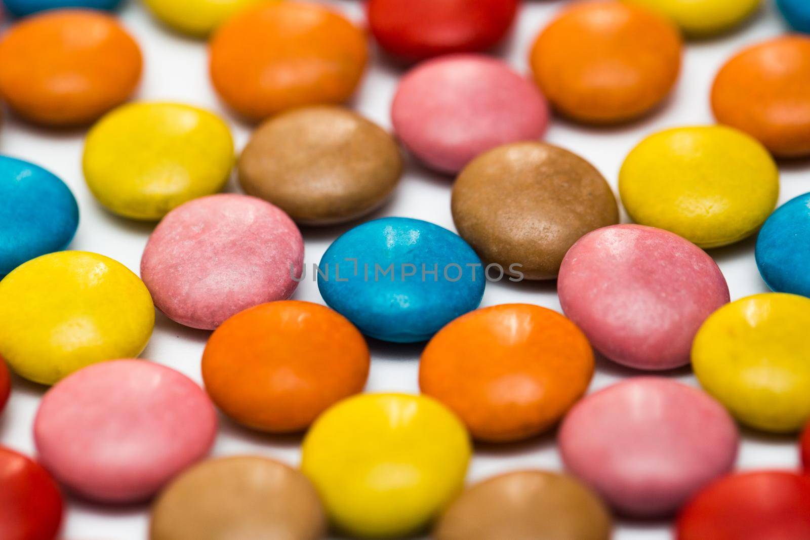 Close up of a pile of colorful chocolate coated candy, chocolate pattern, chocolate background. by StudioPeace