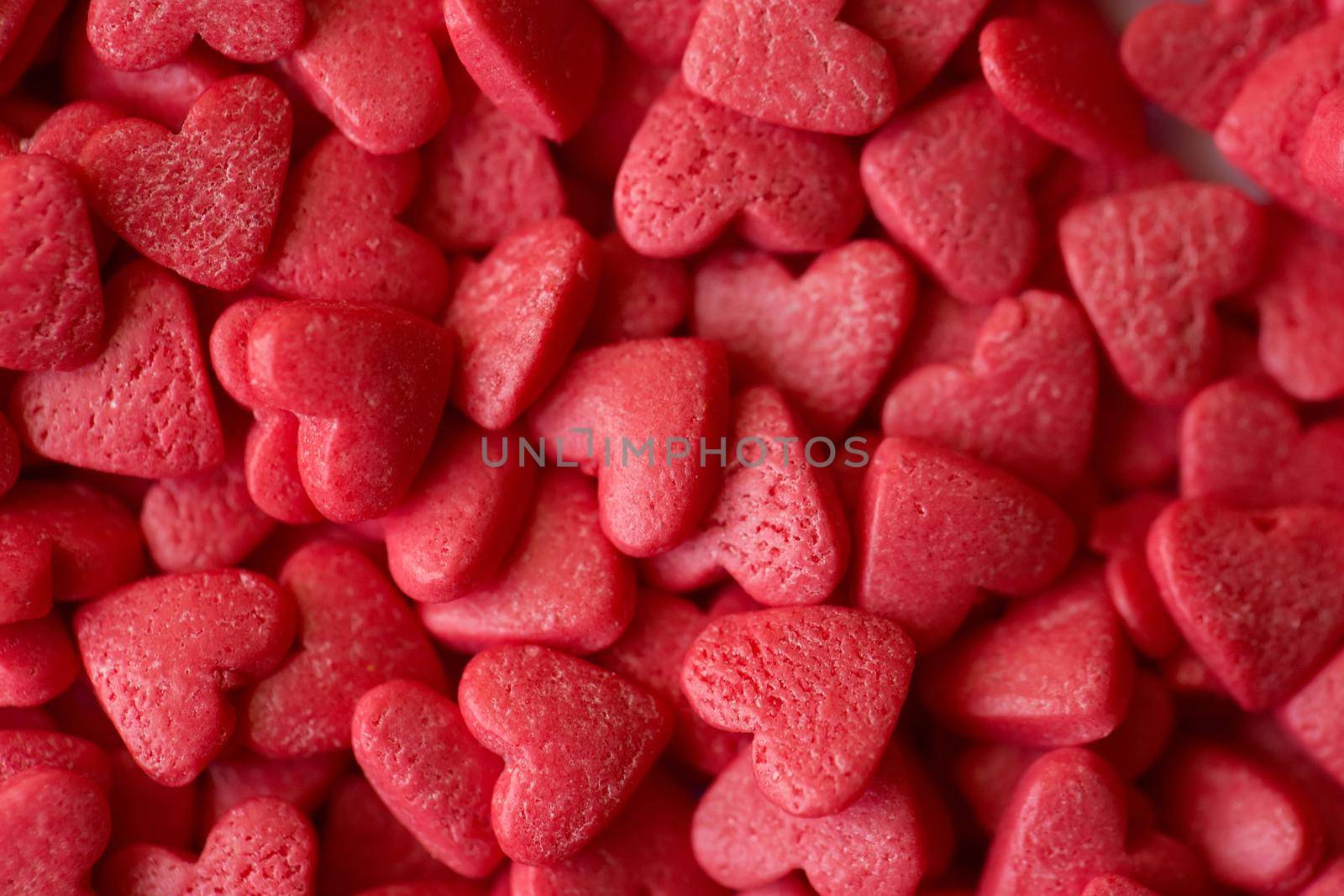 Small red candy hearts, close-up. Macro photography.