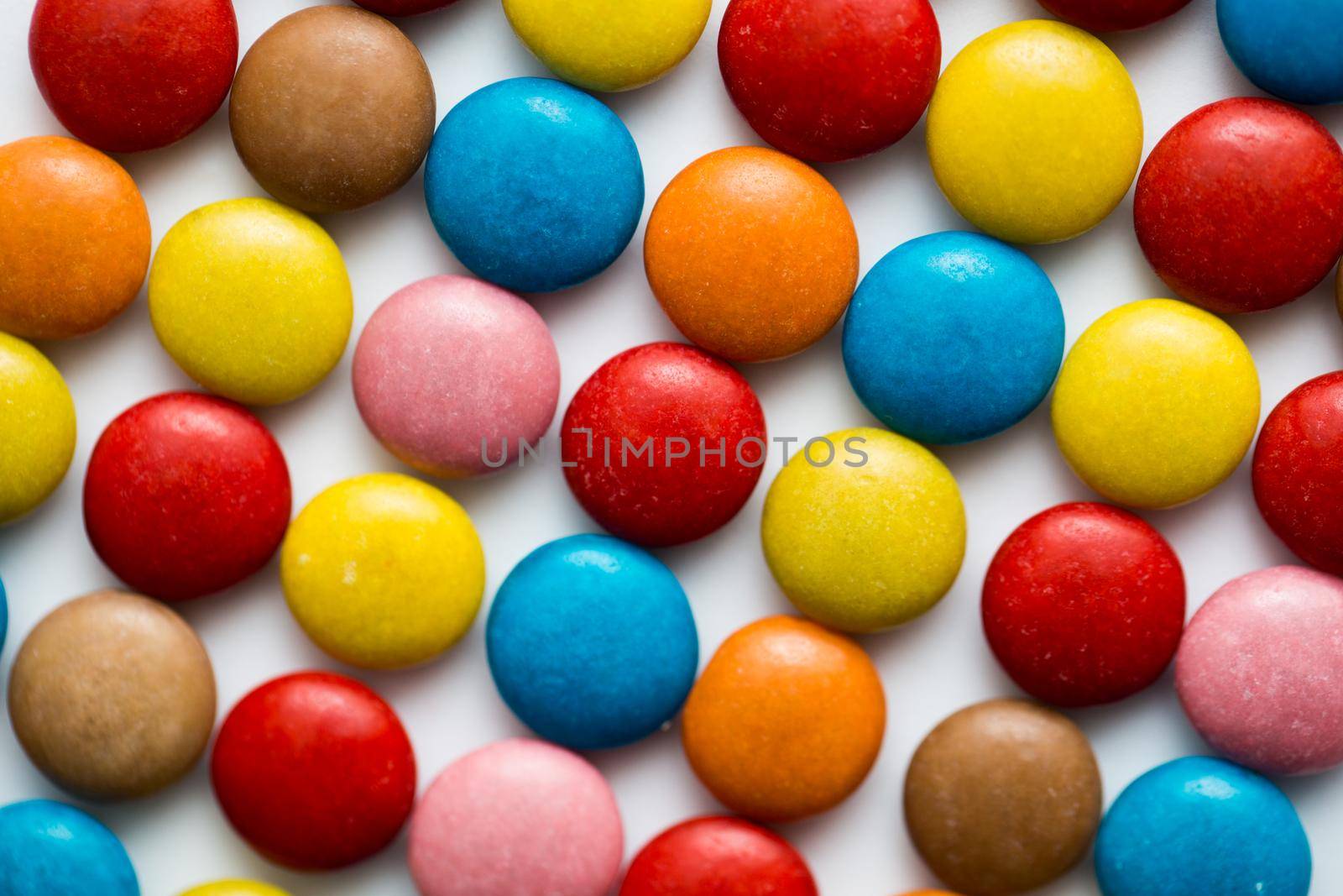 Close up of a pile of colorful chocolate coated candy, chocolate pattern, chocolate background. by StudioPeace
