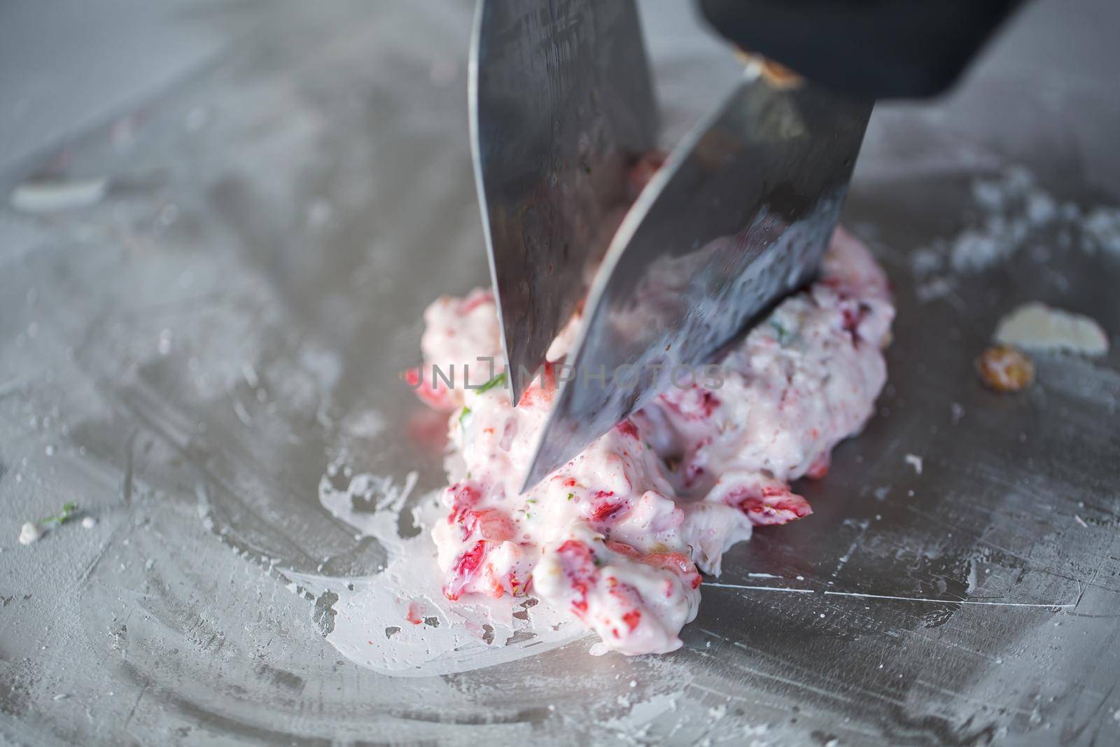 Stir-fried ice cream rolls at freeze pan. Rolled ice cream, hand made ice cream dessert. Fried ice cream machine with steel chilled pan by StudioPeace