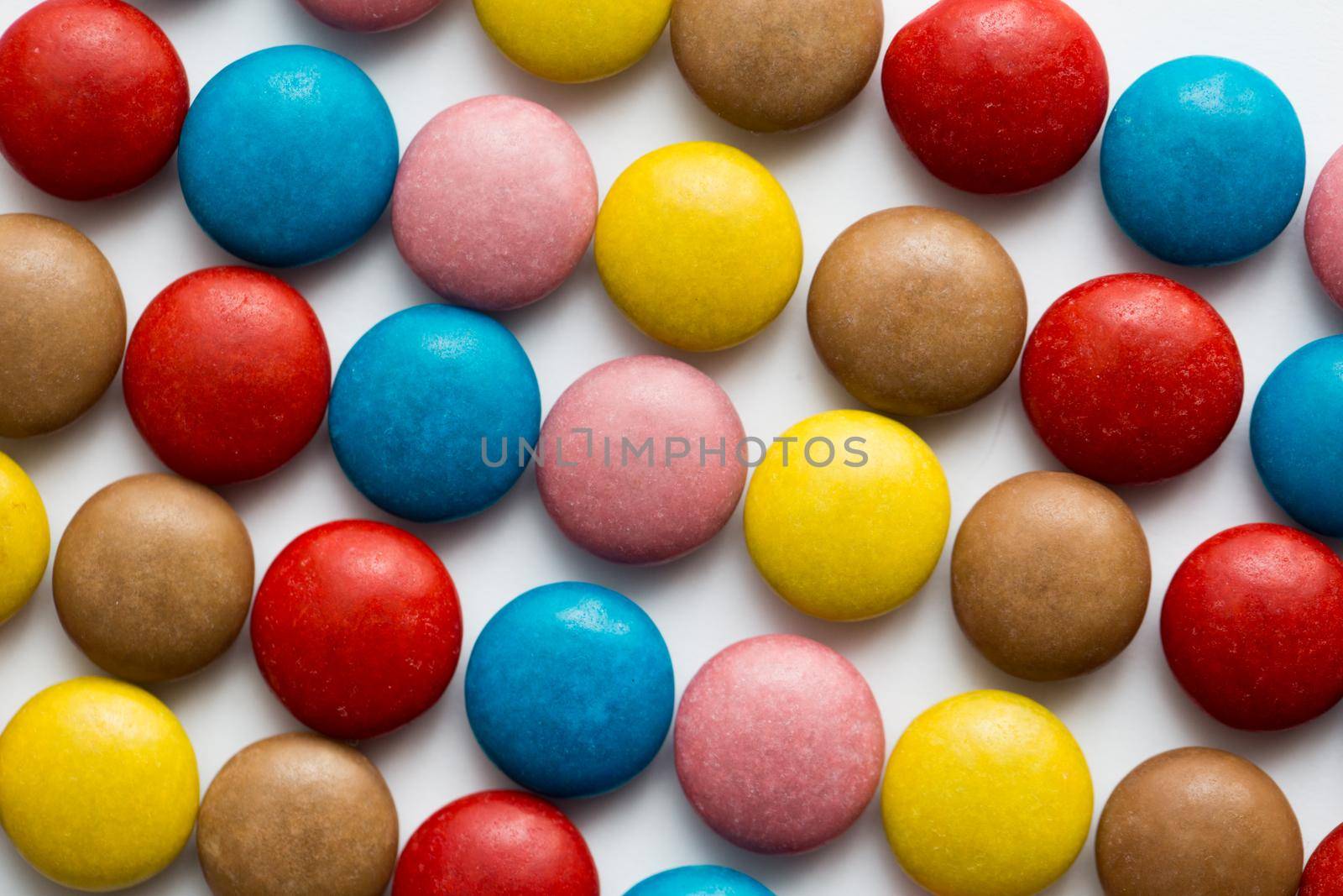 Close up of a pile of colorful chocolate coated candy, chocolate pattern, chocolate background