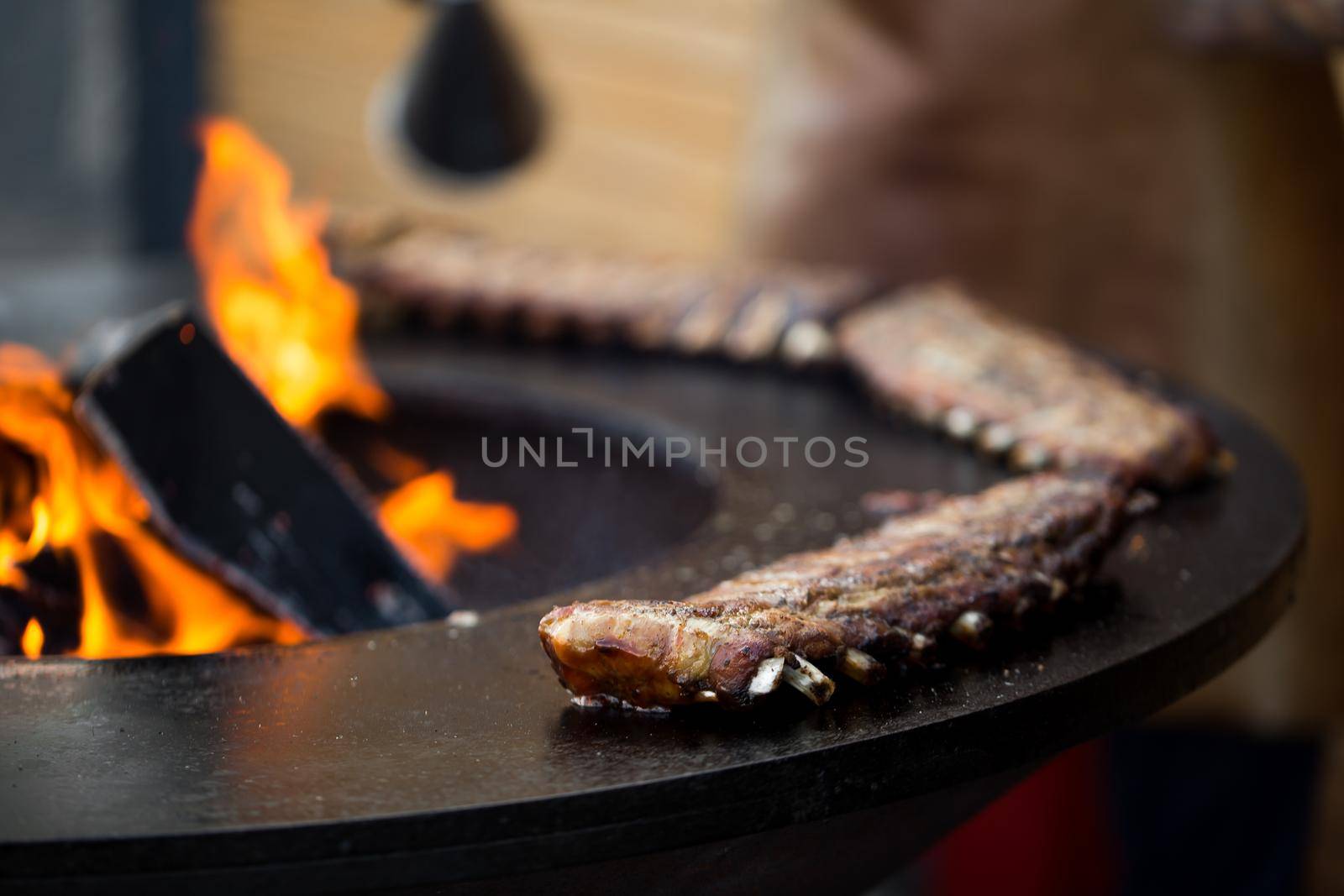 Grilled pork baby ribs with barbecue sauce on the grill. Festival street food