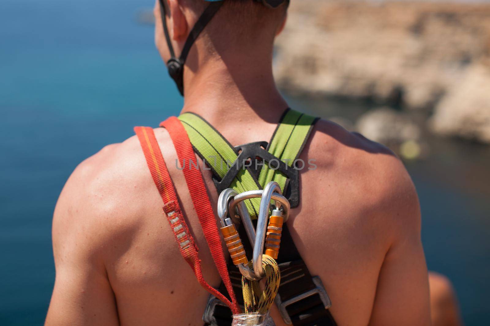 Rope jumping off a cliff with a rope in the water. The ocean. Sea. Mountain.